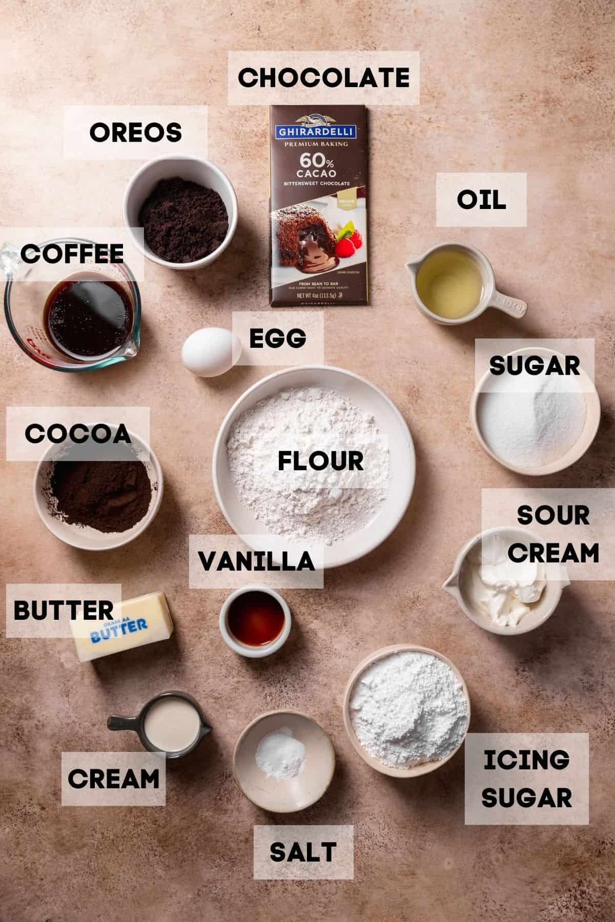 Ingredients needed to make oreo cupcakes in bowls with labels.