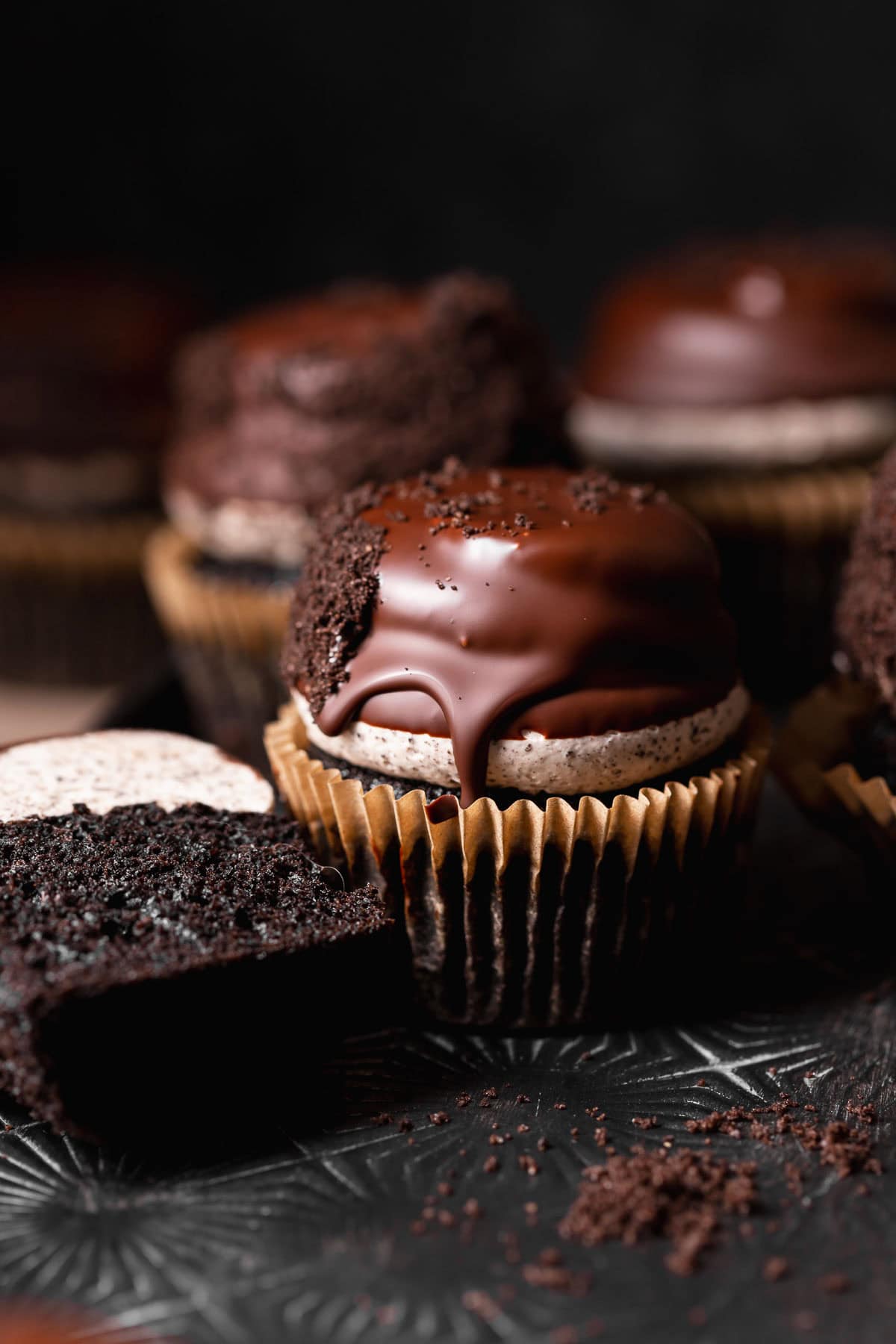 Oreo cupcakes on a black baking sheet.