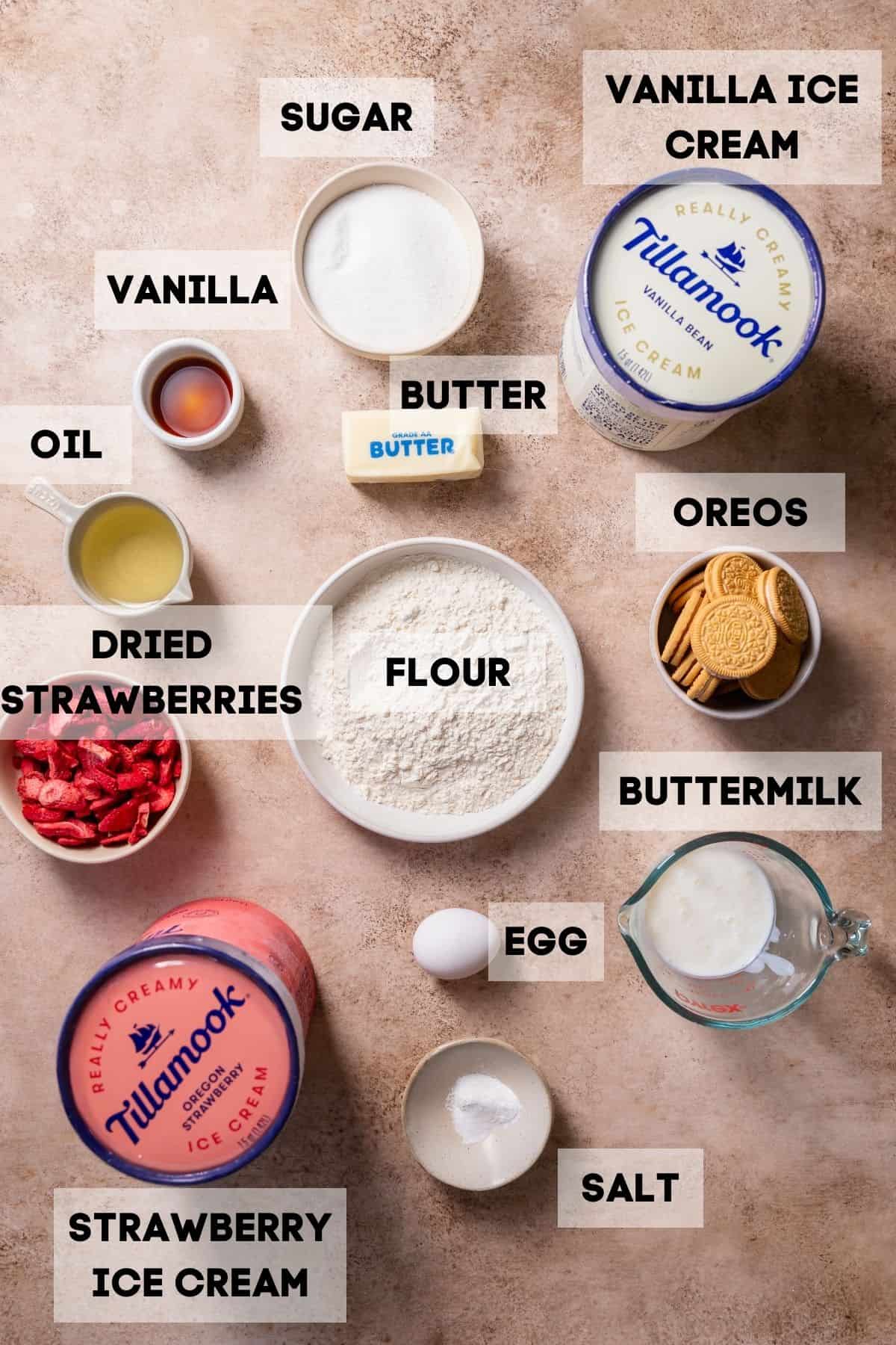 Ingredients needed to make strawberry ice cream cake in bowls with labels.