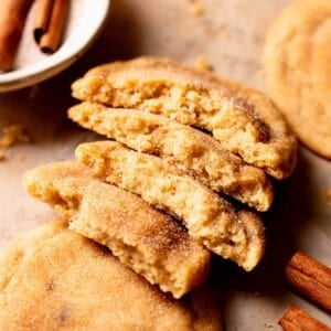 Brown butter snickerdoodle cookies broken in half to show the soft and chewy texture.
