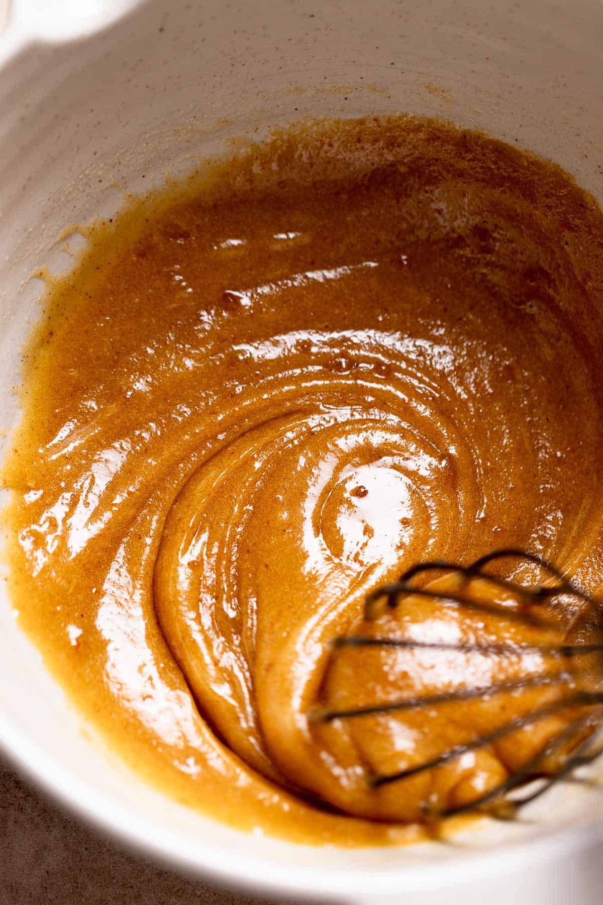 A mixing bowl with the whisked butter, sugar, and eggs.