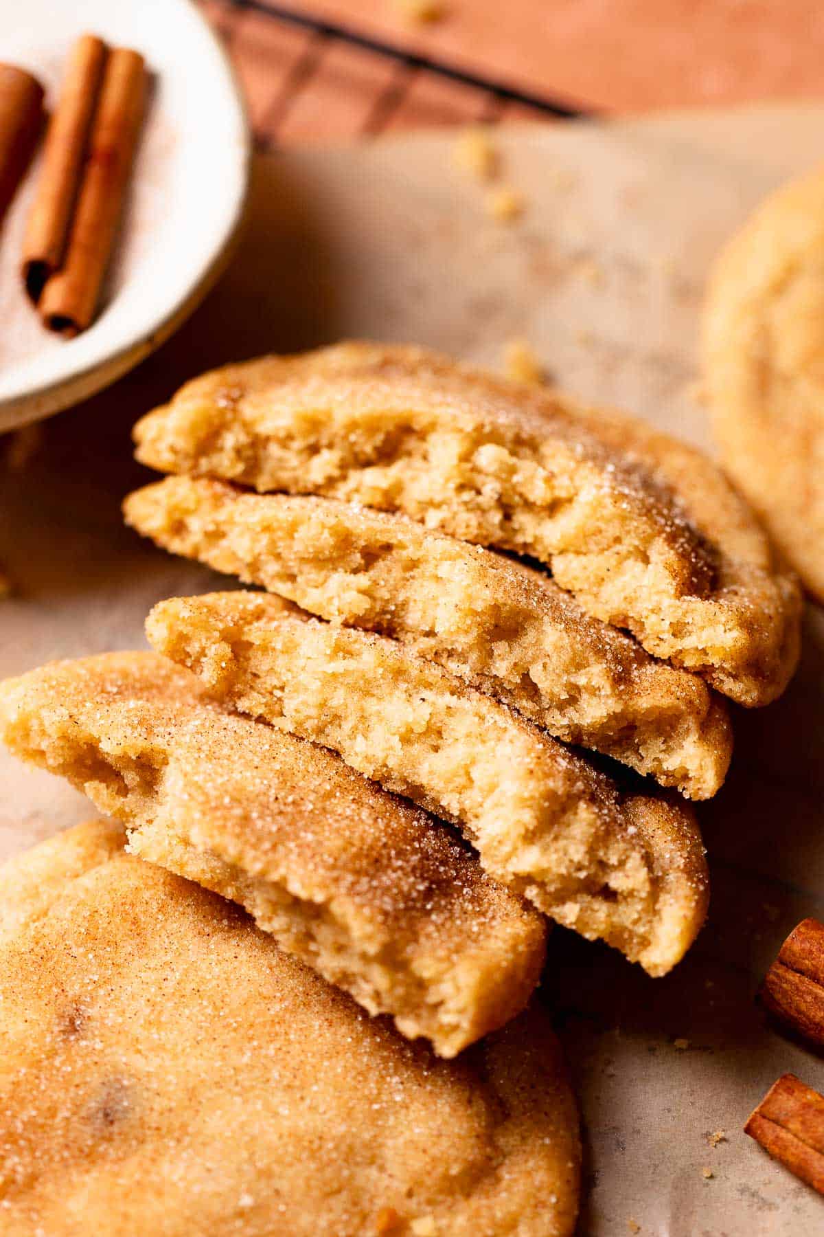 Brown butter snickerdoodles broken in half to show the soft and chewy texture.