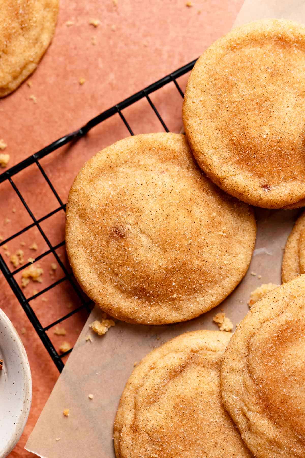 Brown butter snickerdoodle cookies on a wire cooling rack.