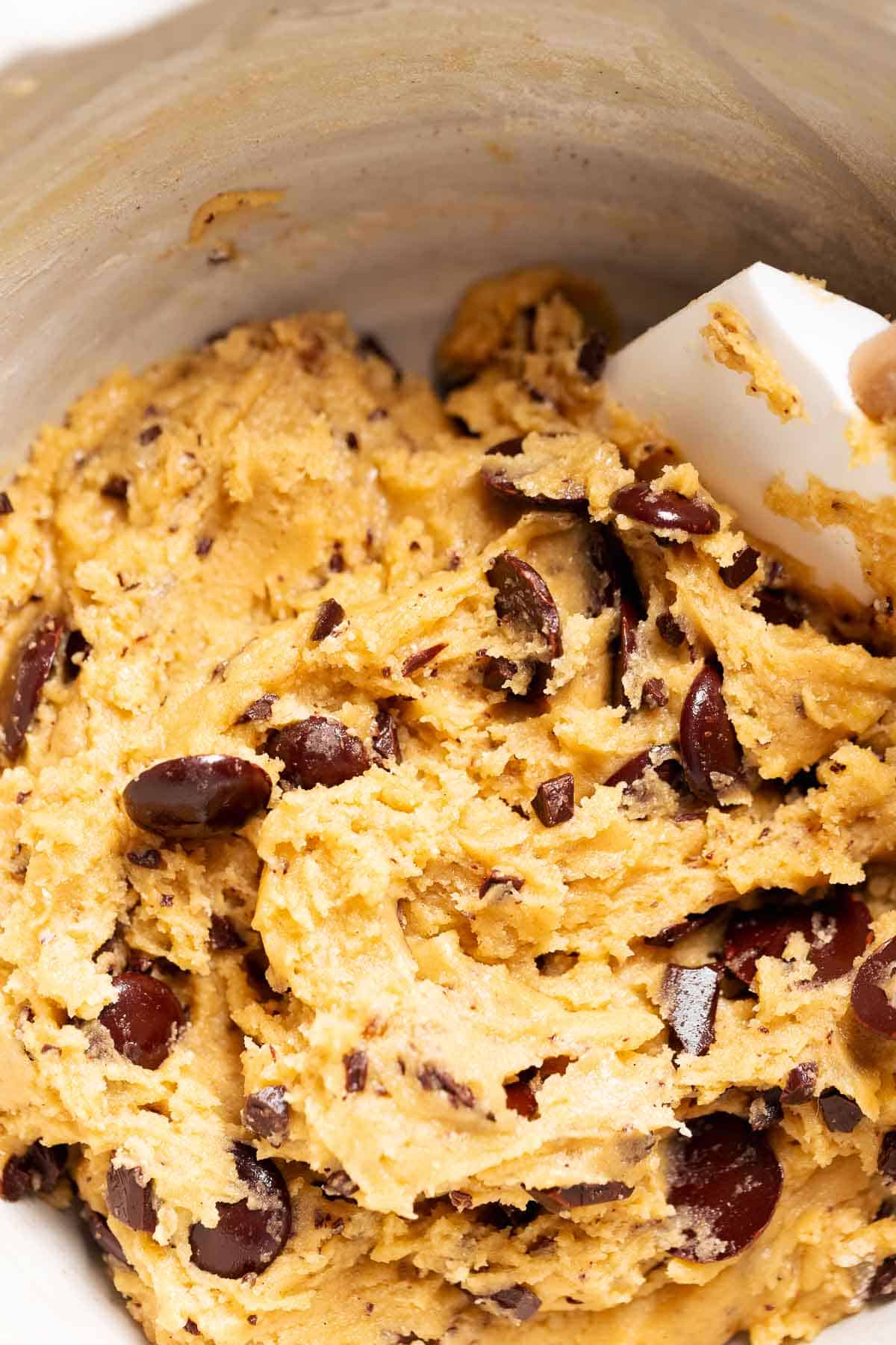 A mixing bowl with the chocolate chip cookie dough before scooping.