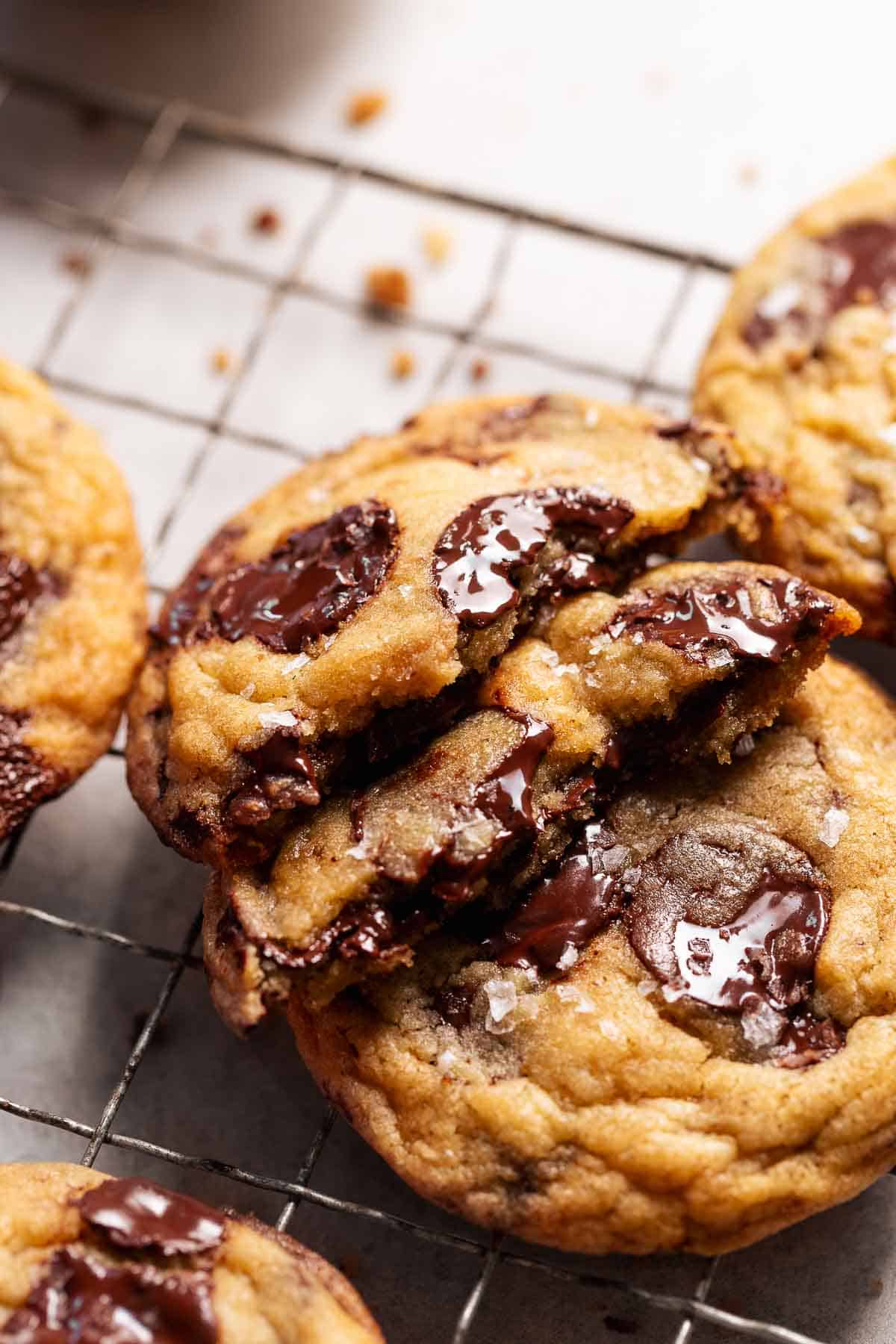 Miso chocolate chip cookie broken in half to show the gooey chocolate centers.