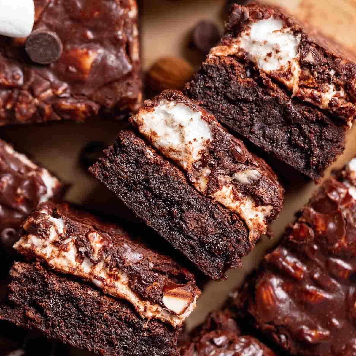 Rocky road brownies on their sides to show the fudgy texture and gooey marshmallow layer.