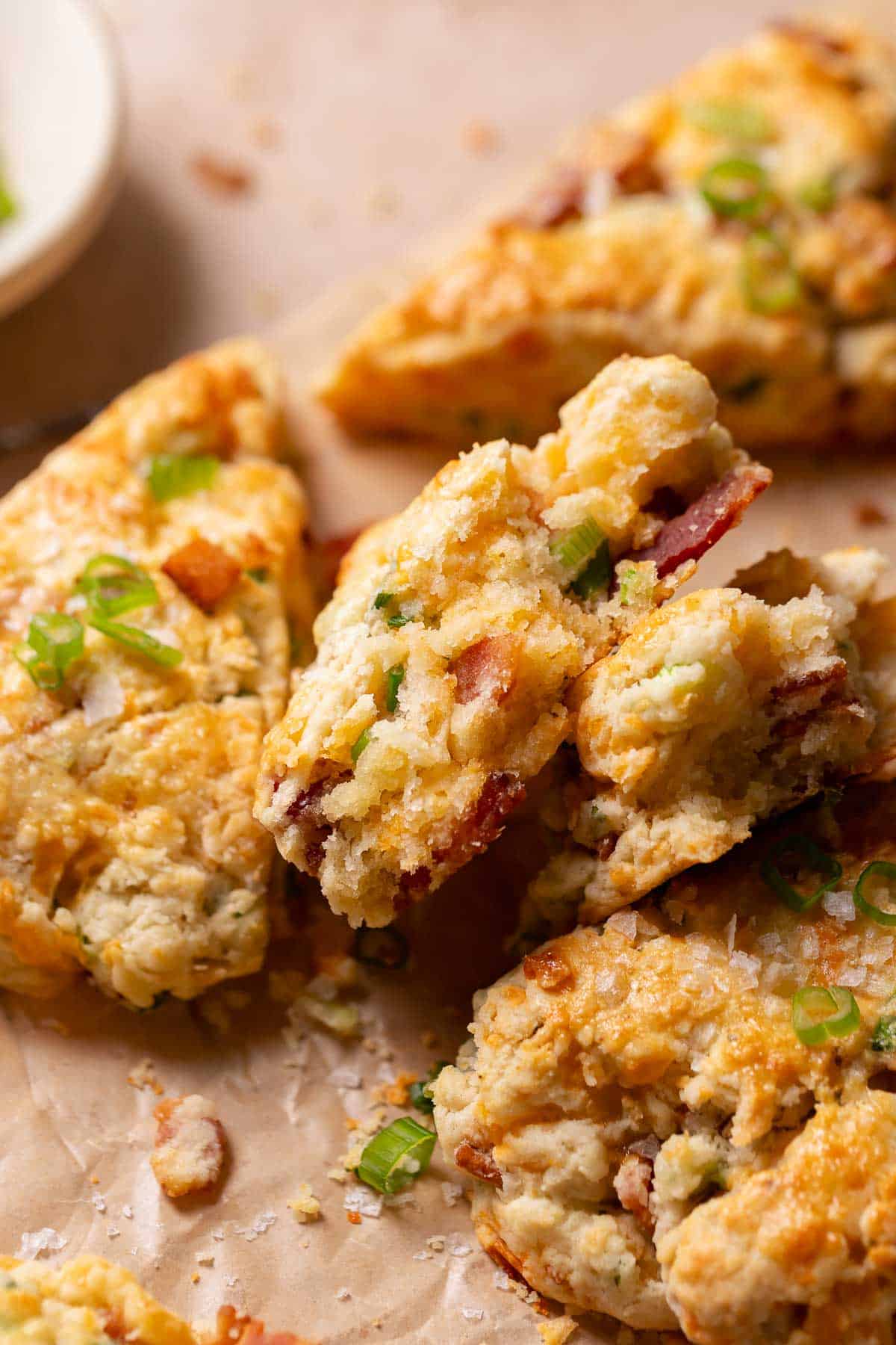 Bacon cheddar scones broken in half to show the soft and tender texture.