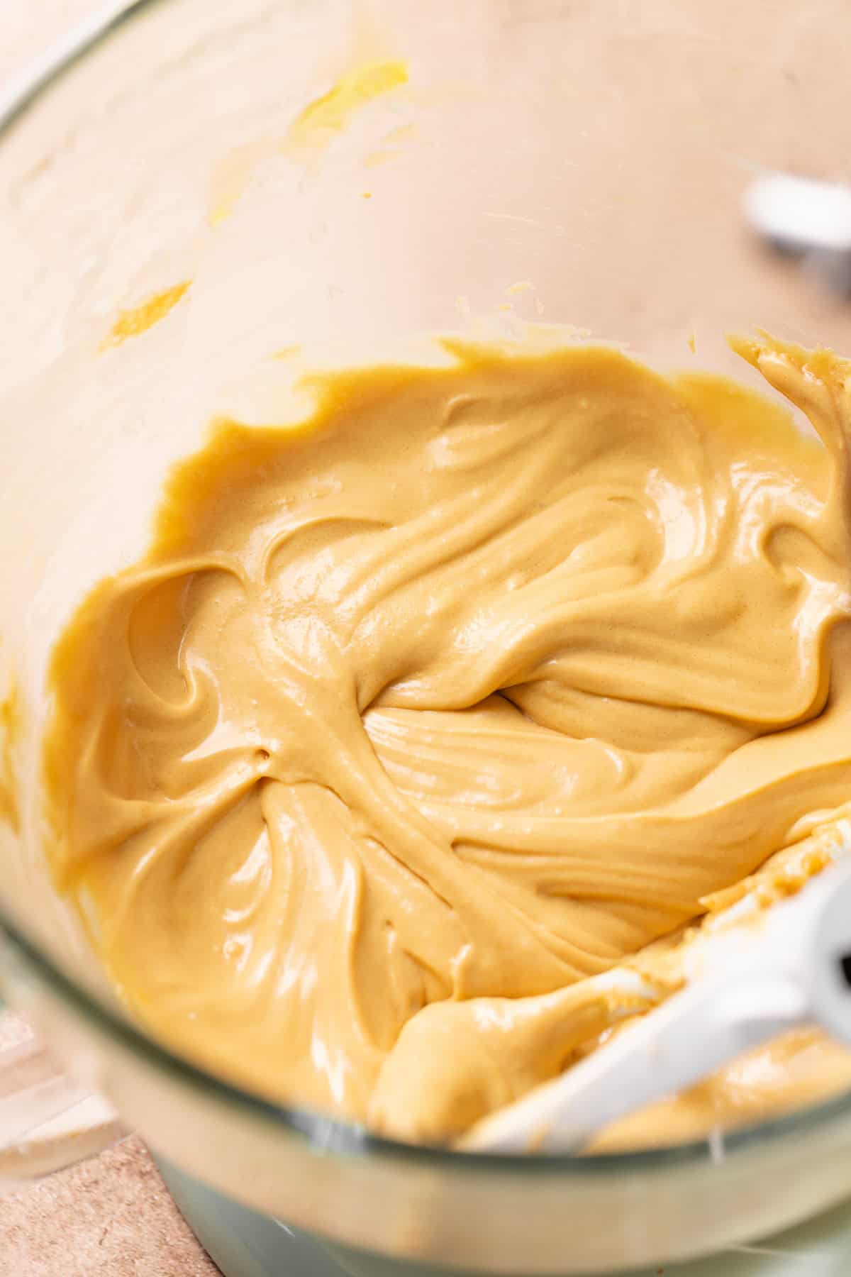 A mixing bowl with the creamed butter and sugar after the eggs are added.