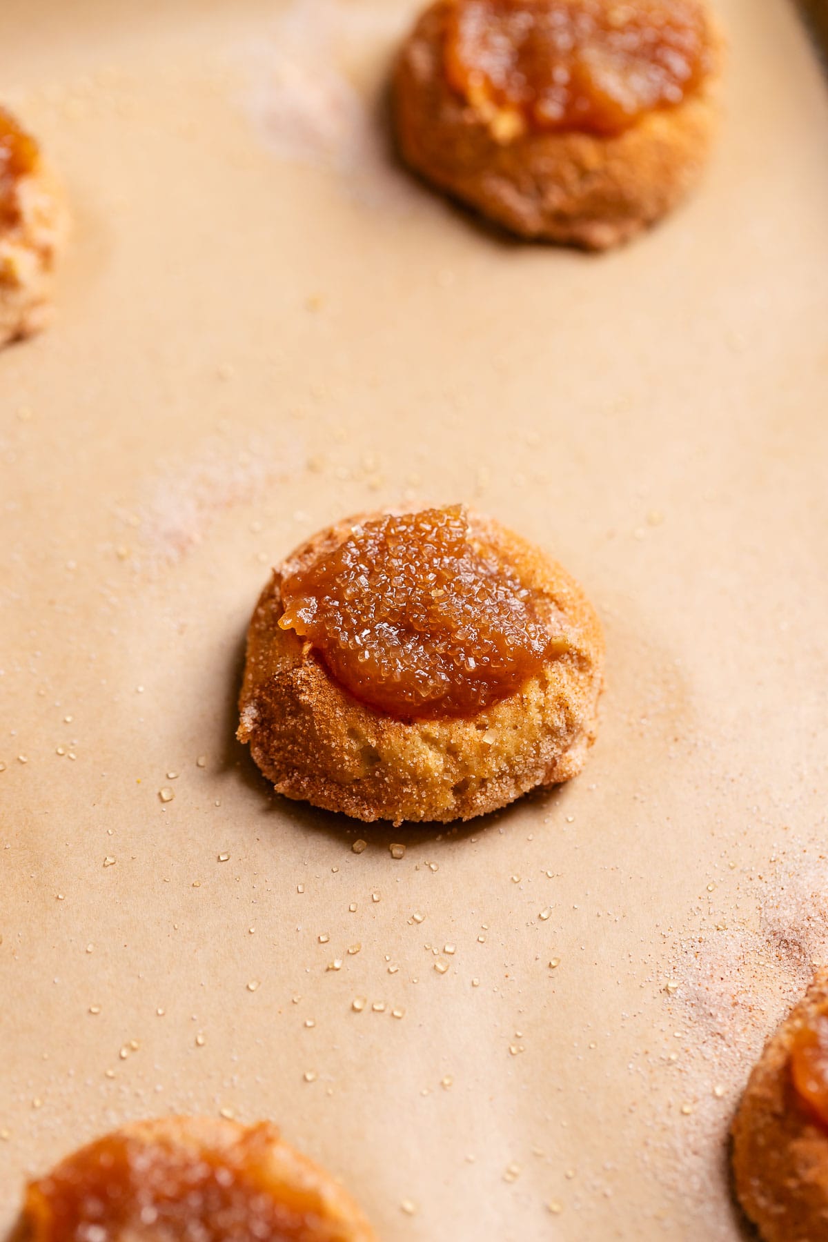 An apple butter filled snickerdoodle on a baking tray before baking.