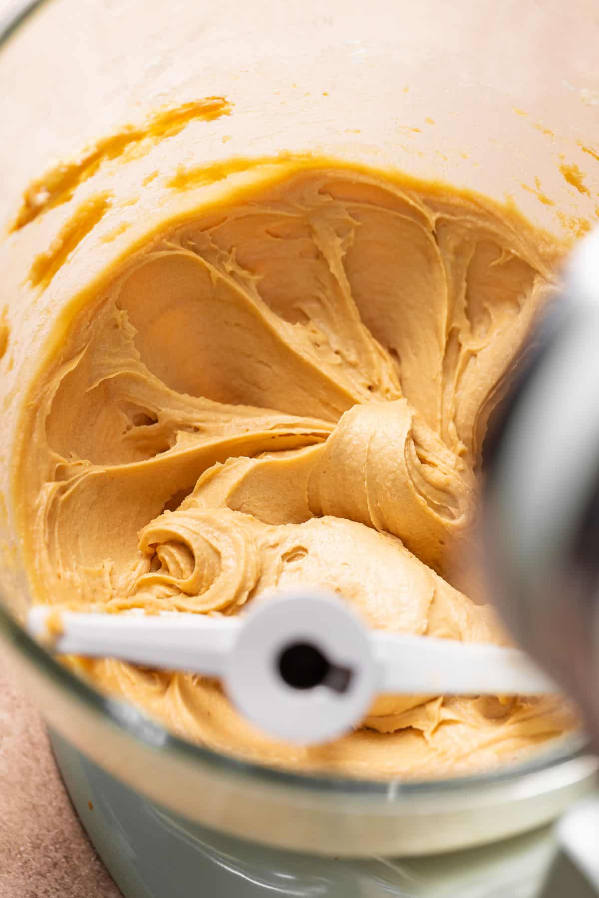 A mixing bowl with the creamed butter, sugar, apple butter, and molasses.