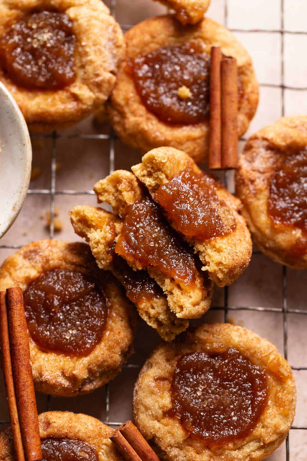 Apple butter cookies cut in half on a wire cooling rack.