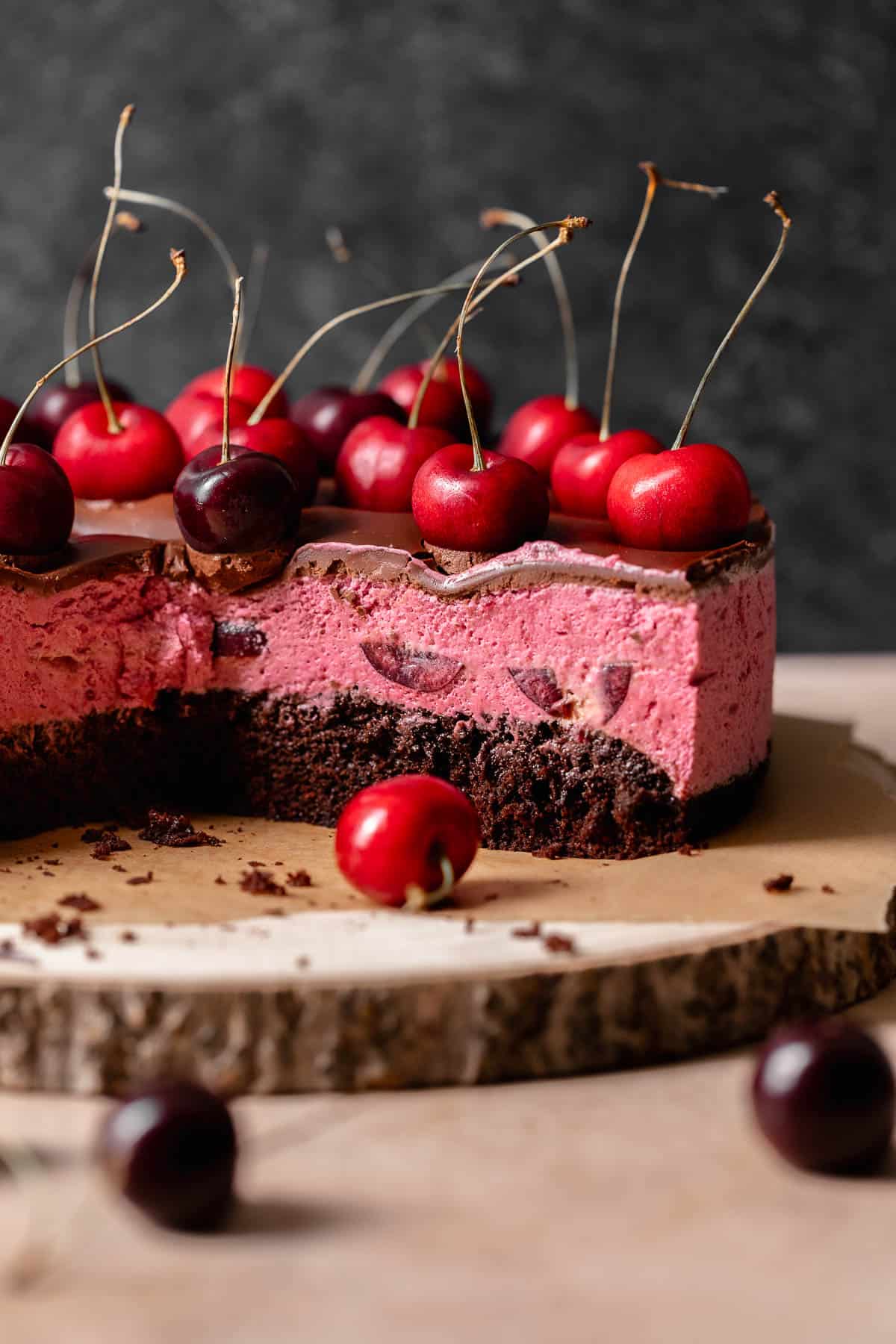 Chocolate cherry cake with slices missing to show the cherry filling texture.