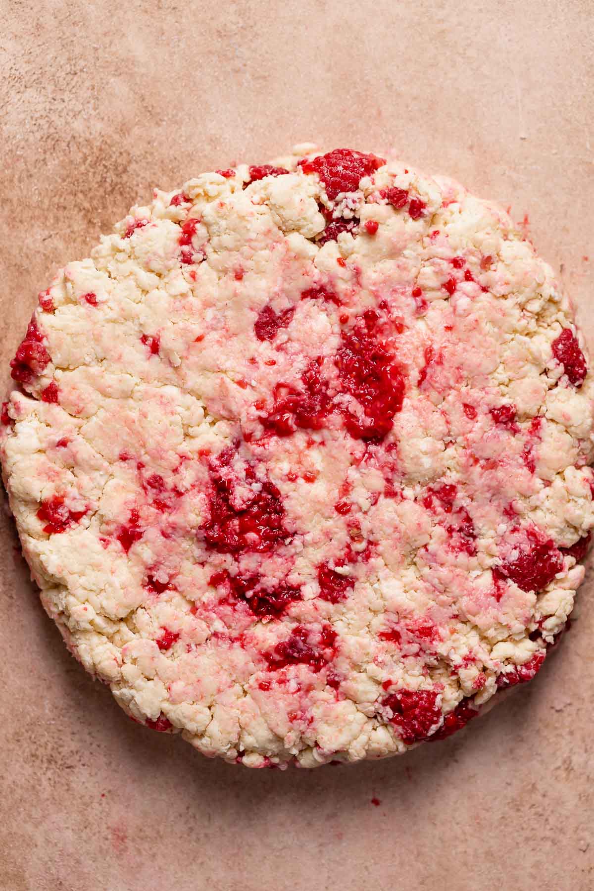 Raspberry scone dough formed into a round before cutting.