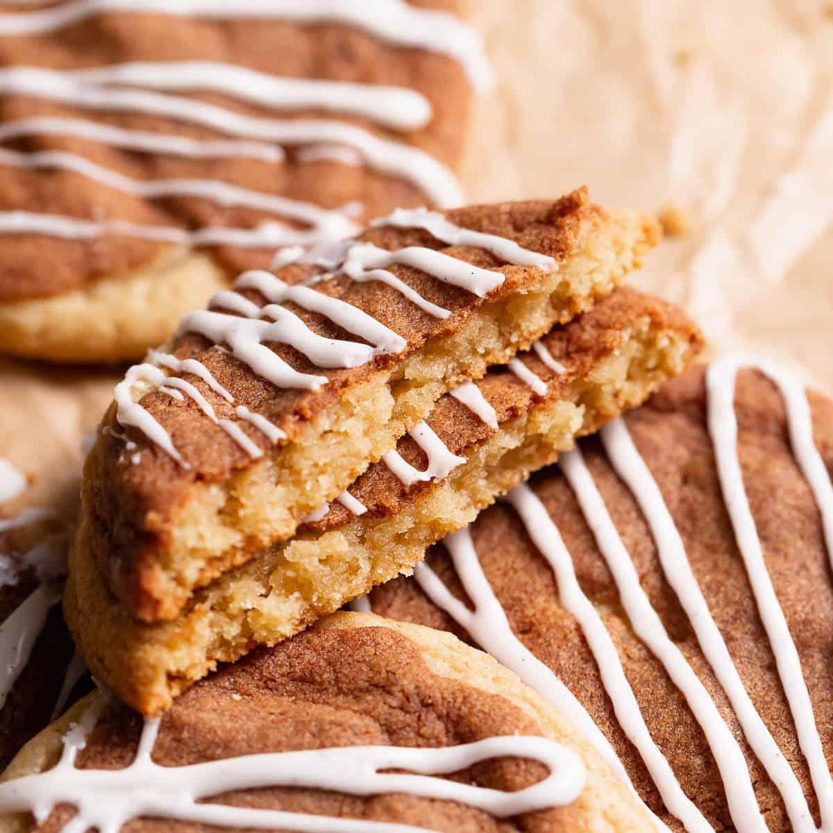 Cinnamon roll cookie broken in half to show the cinnamon sugar layer.