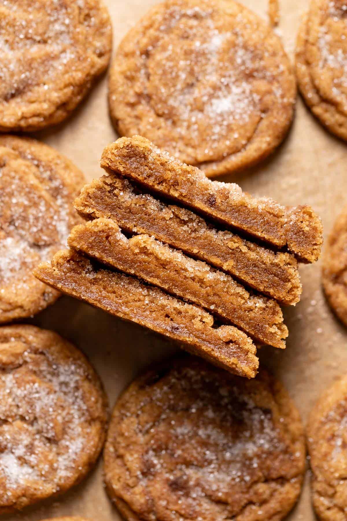 Pumpkin spice snickerdoodles cut in half to show the chewy texture.