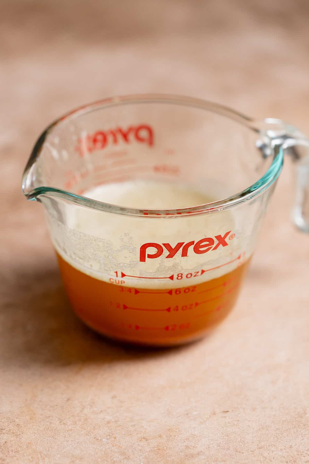 A glass measuring cup with browned butter.