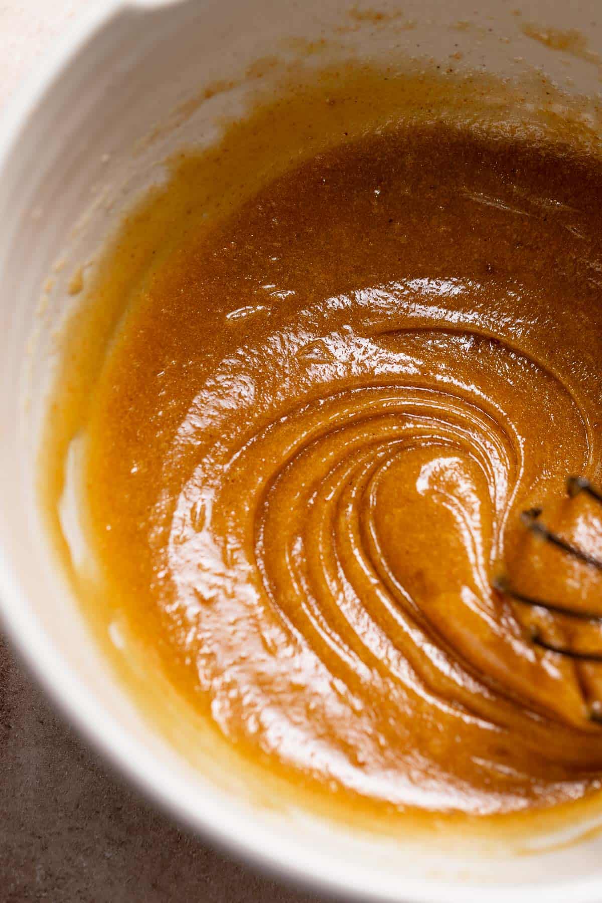 A mixing bowl with the whisked brown butter, sugar, and eggs.