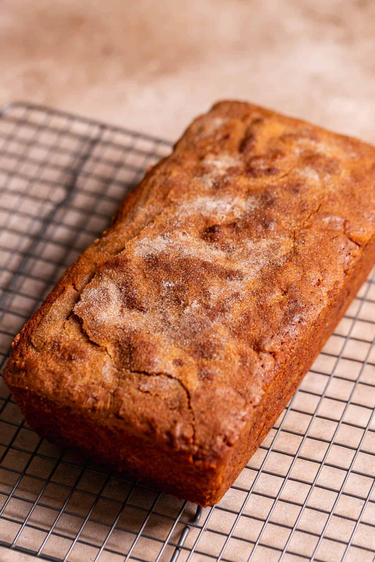 Apple loaf cake cooling on a wire rack.