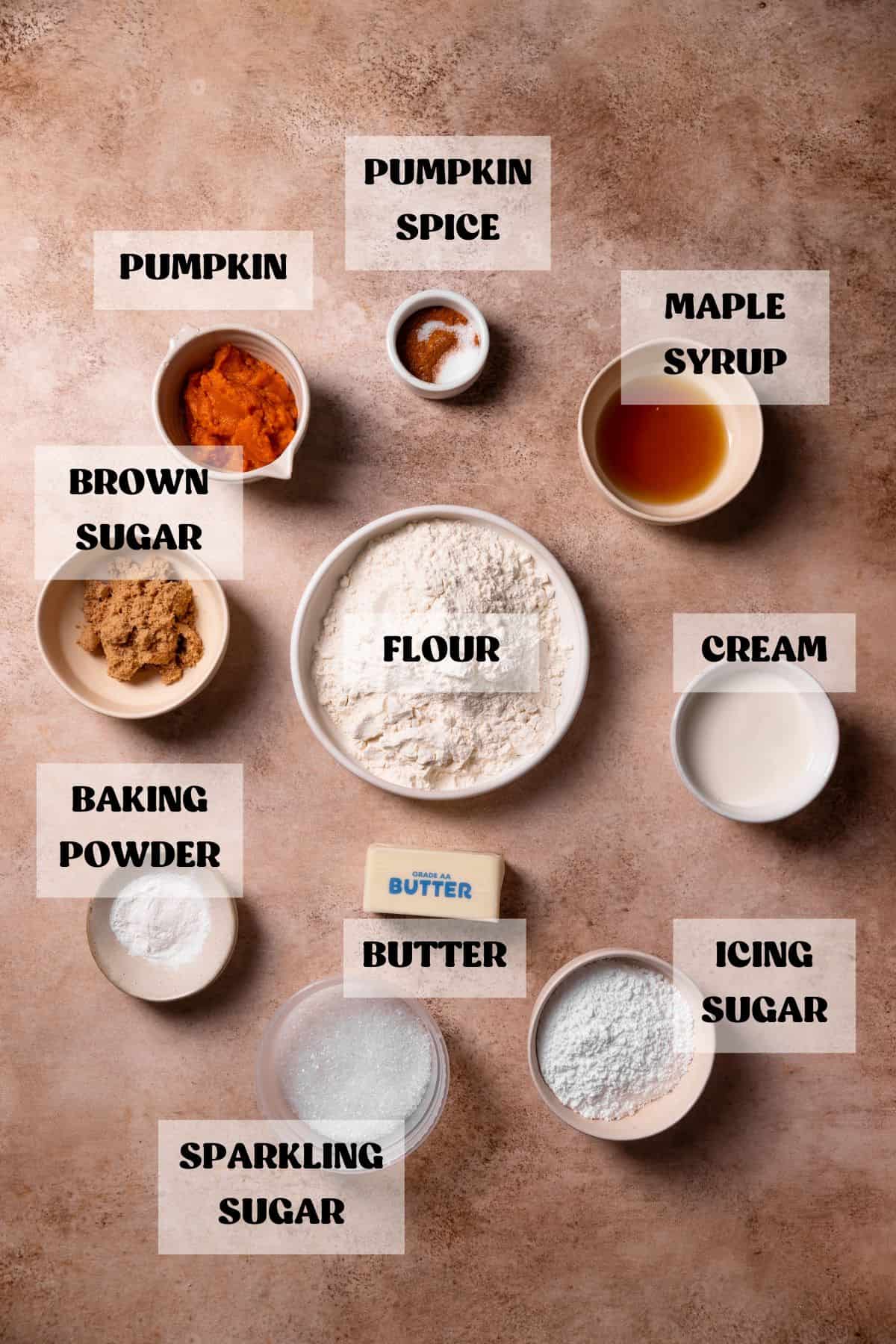 Ingredients needed to make pumpkin spice scones in bowls with labels.