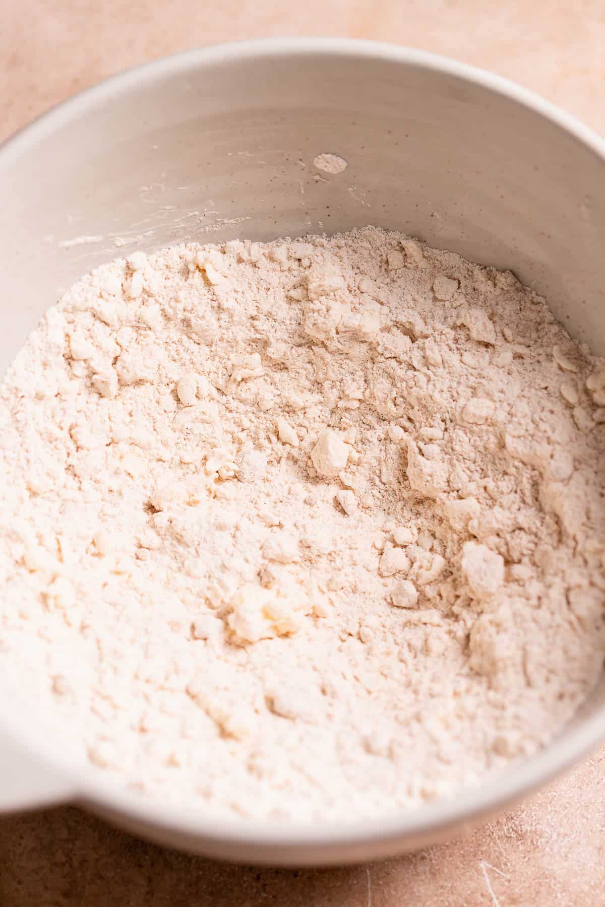 A mixing bowl with the frozen butter mixed into the flour.