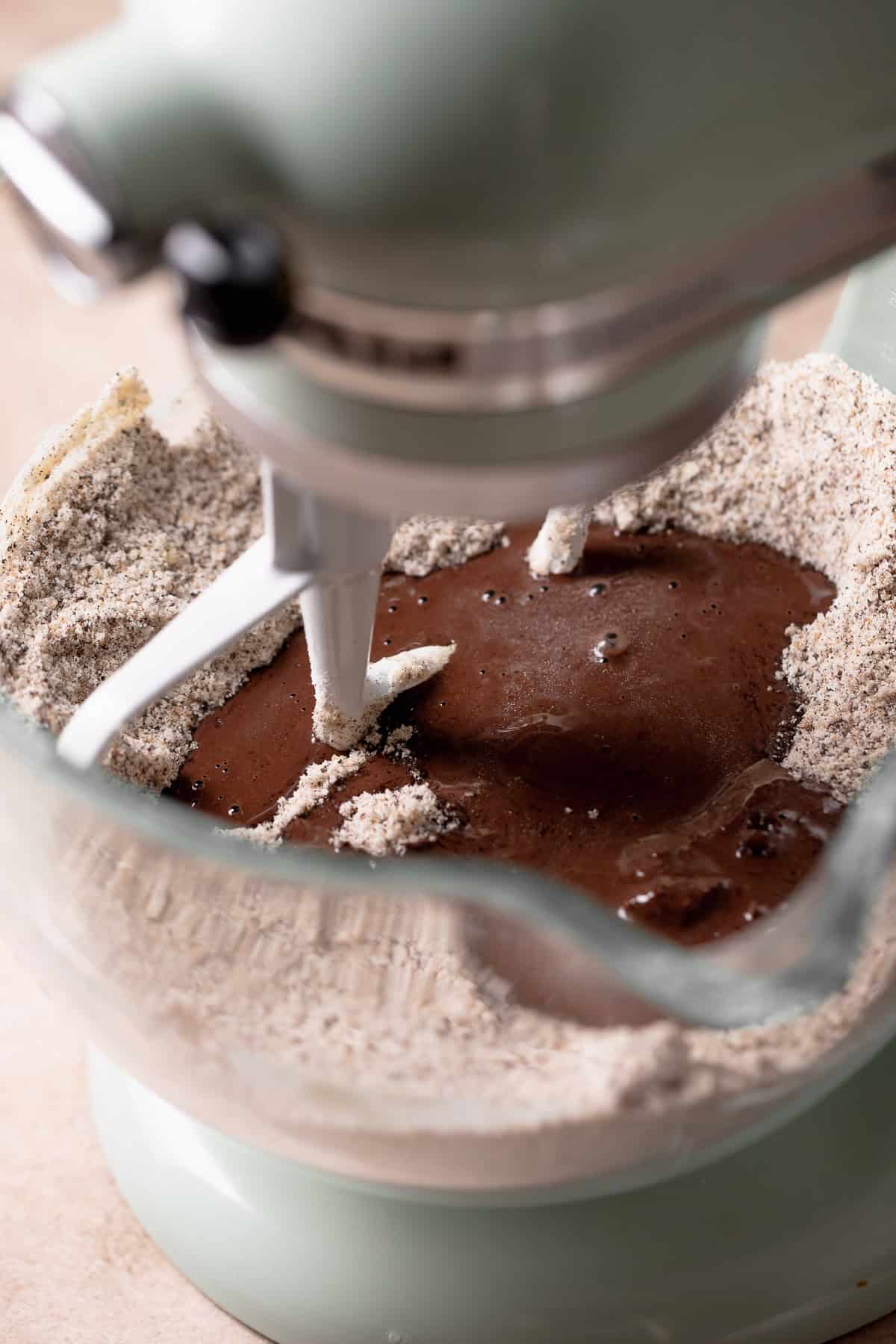 The wet ingredients being mixed into the dry ingredients in a mixing bowl.