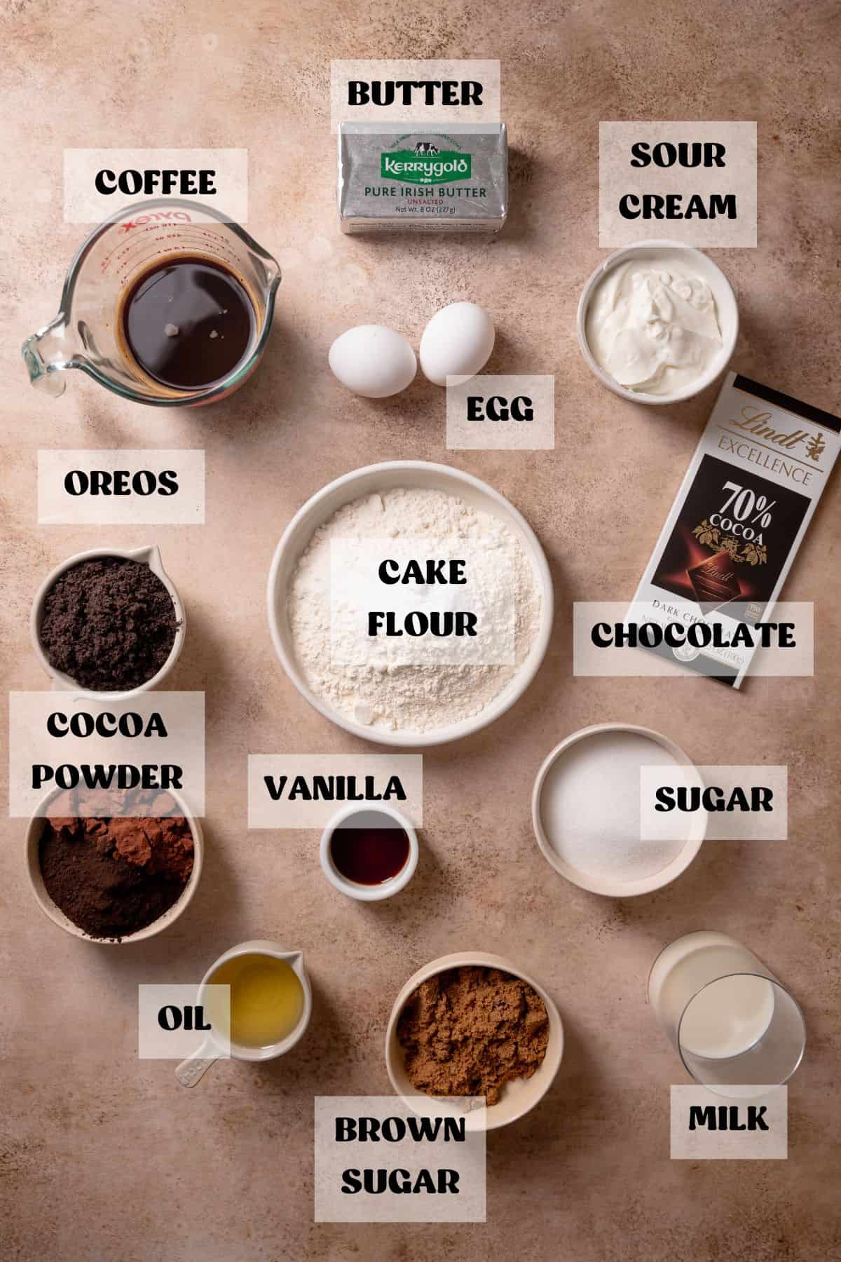 Ingredients needed to make chocolate cake with oreos in bowls with labels.