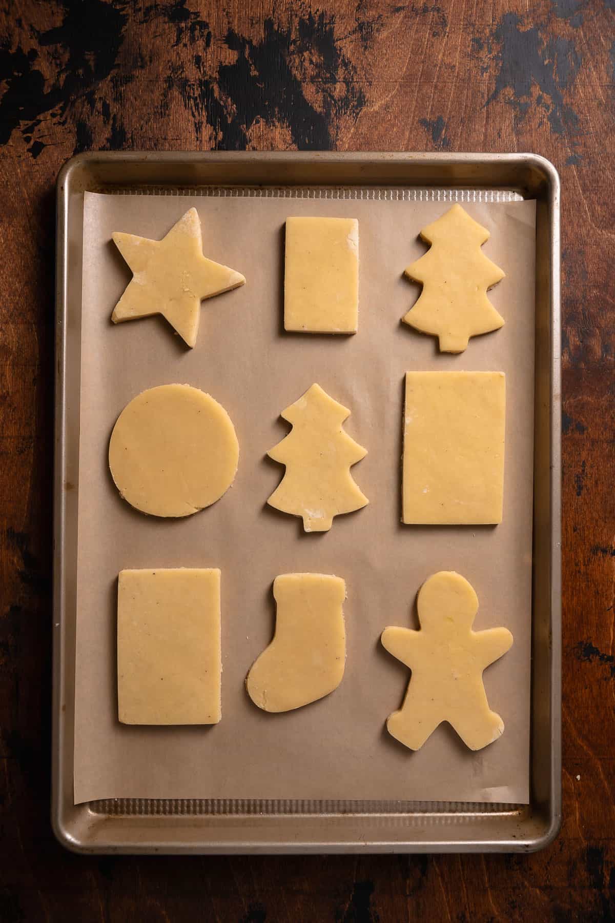 Sugar cookie cut outs on a baking sheet before freezing.