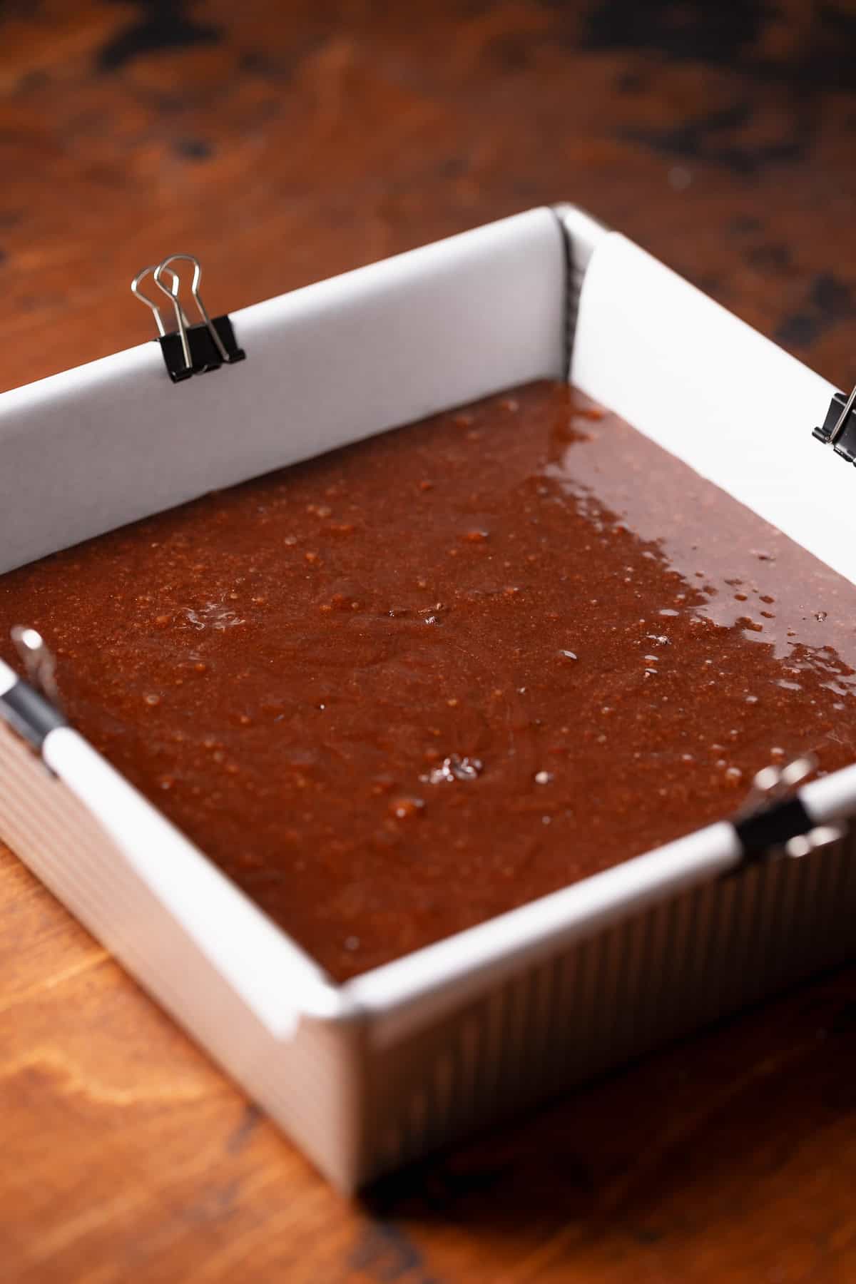 A square pan with the brownie batter before baking.