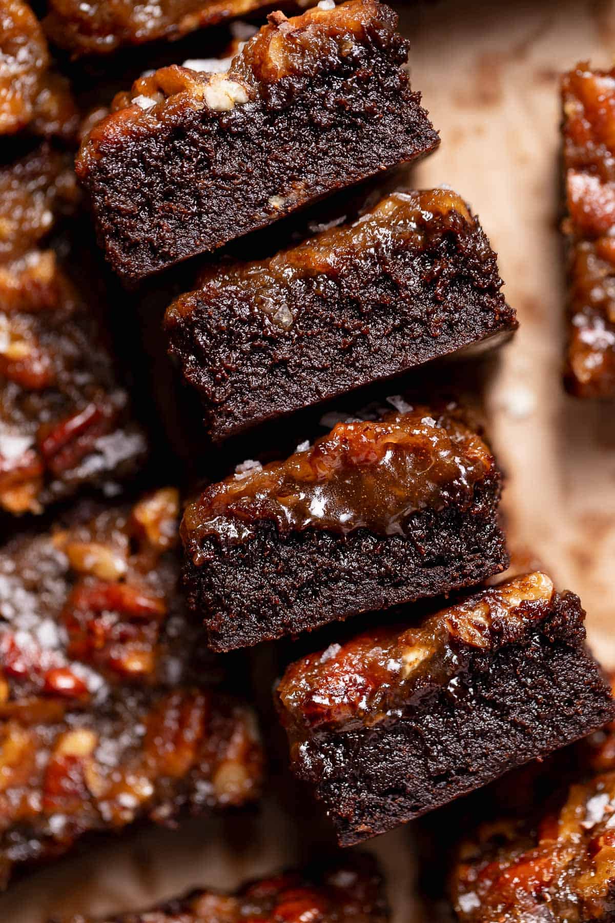 Pecan pie brownies on their sides to show the layers of pecan filling and brownie.