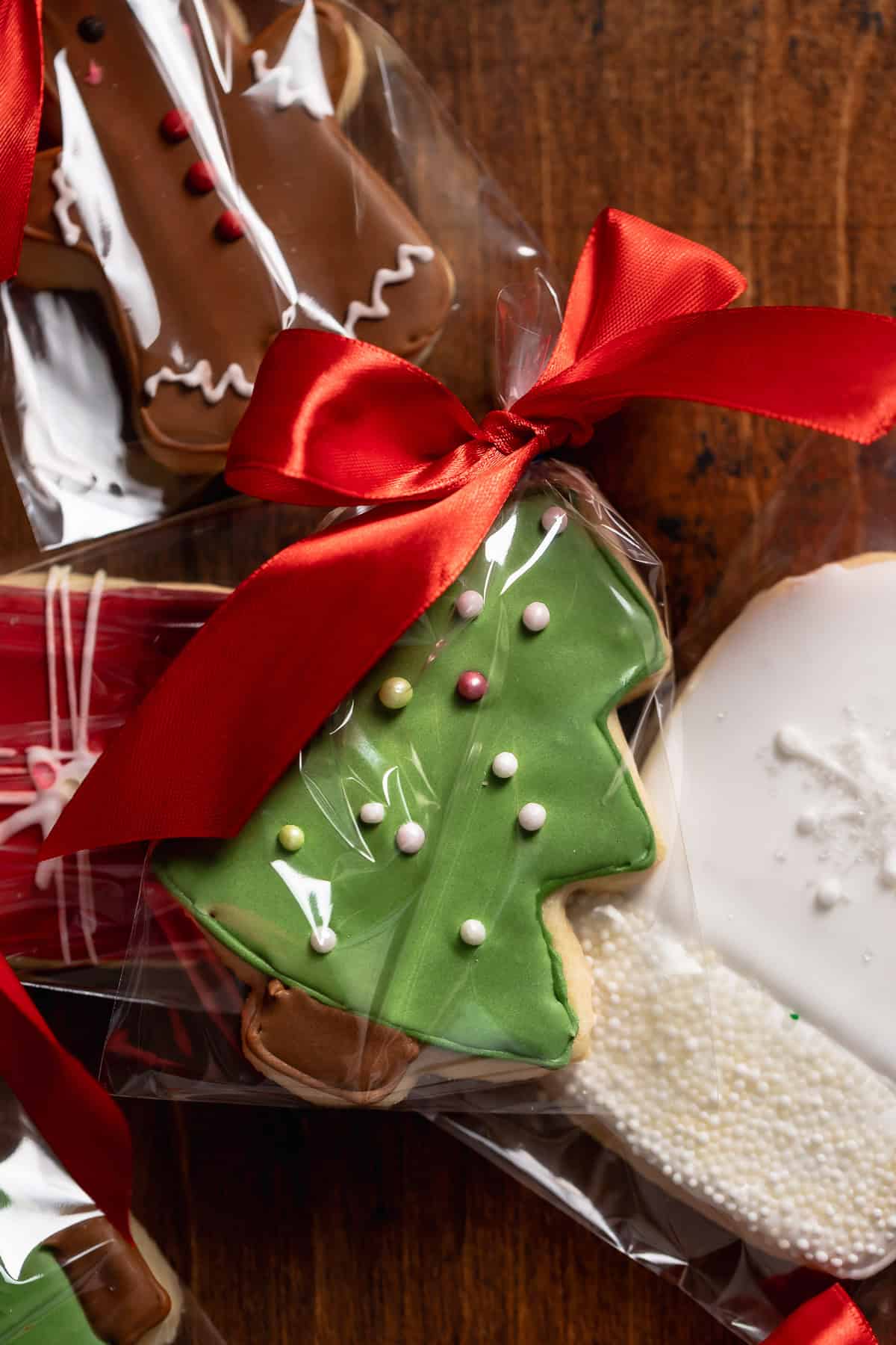 Decorated sugar cookies in cellophane bags with ribbon tied on top.