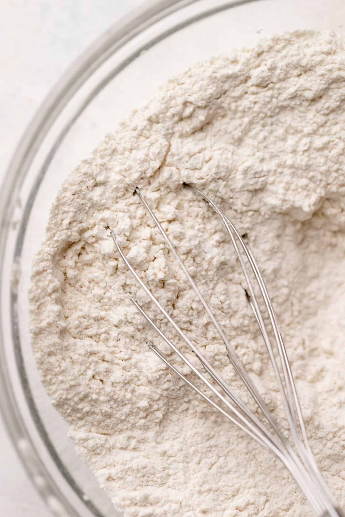 Dry ingredients being whisked in a bowl.