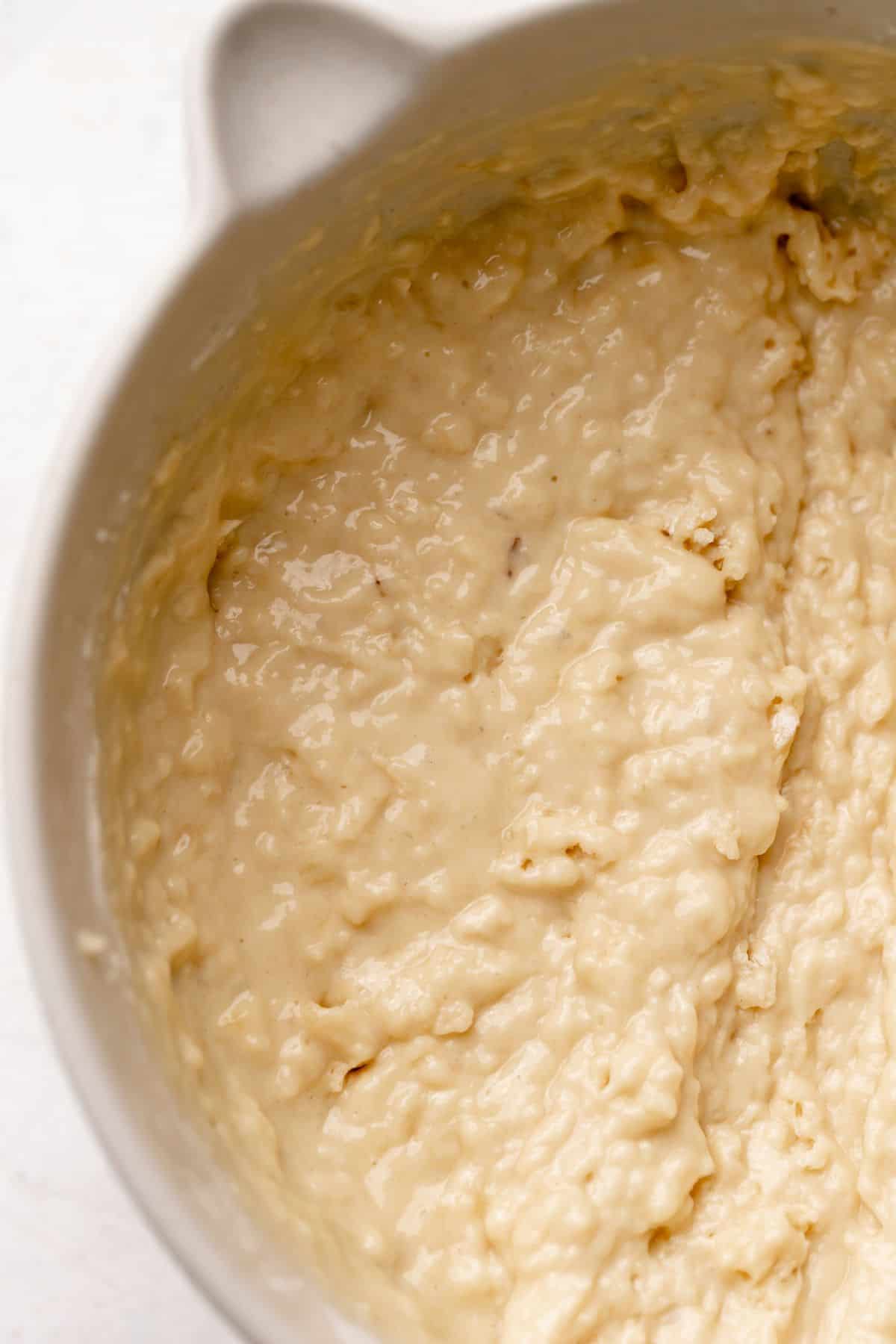 Banana muffin batter in a mixing bowl.