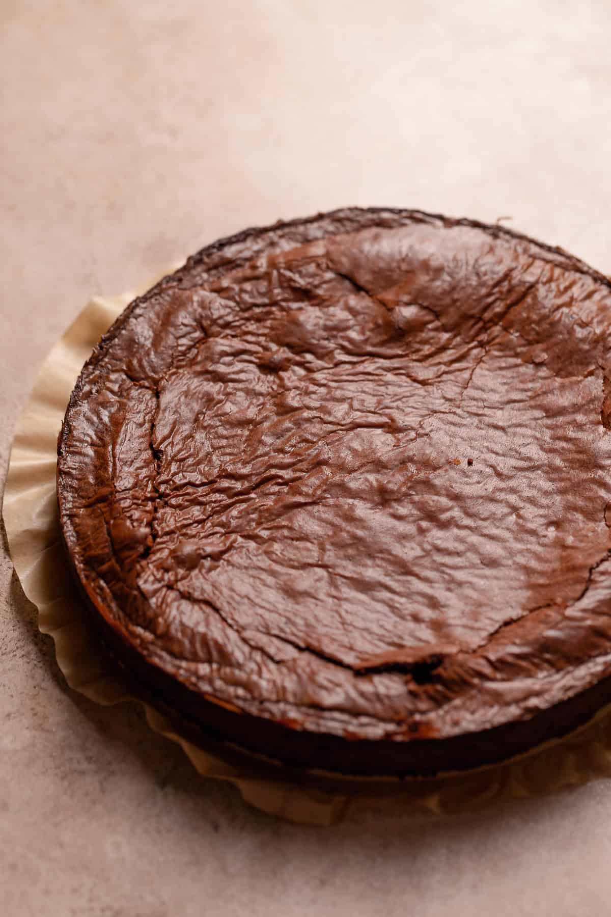 The brownie cake after baking on parchment paper.