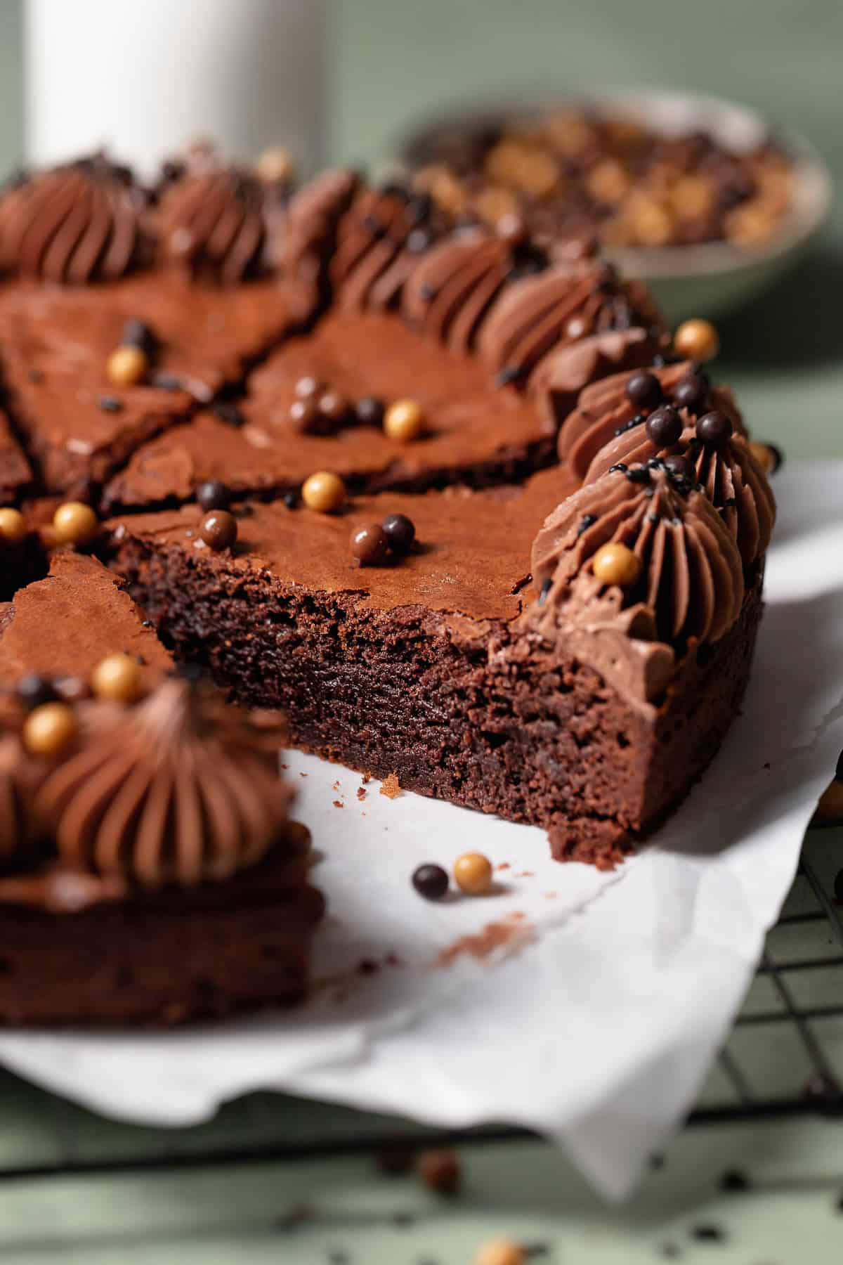 A piece of brownie cake pulled out to show the fudgy texture.