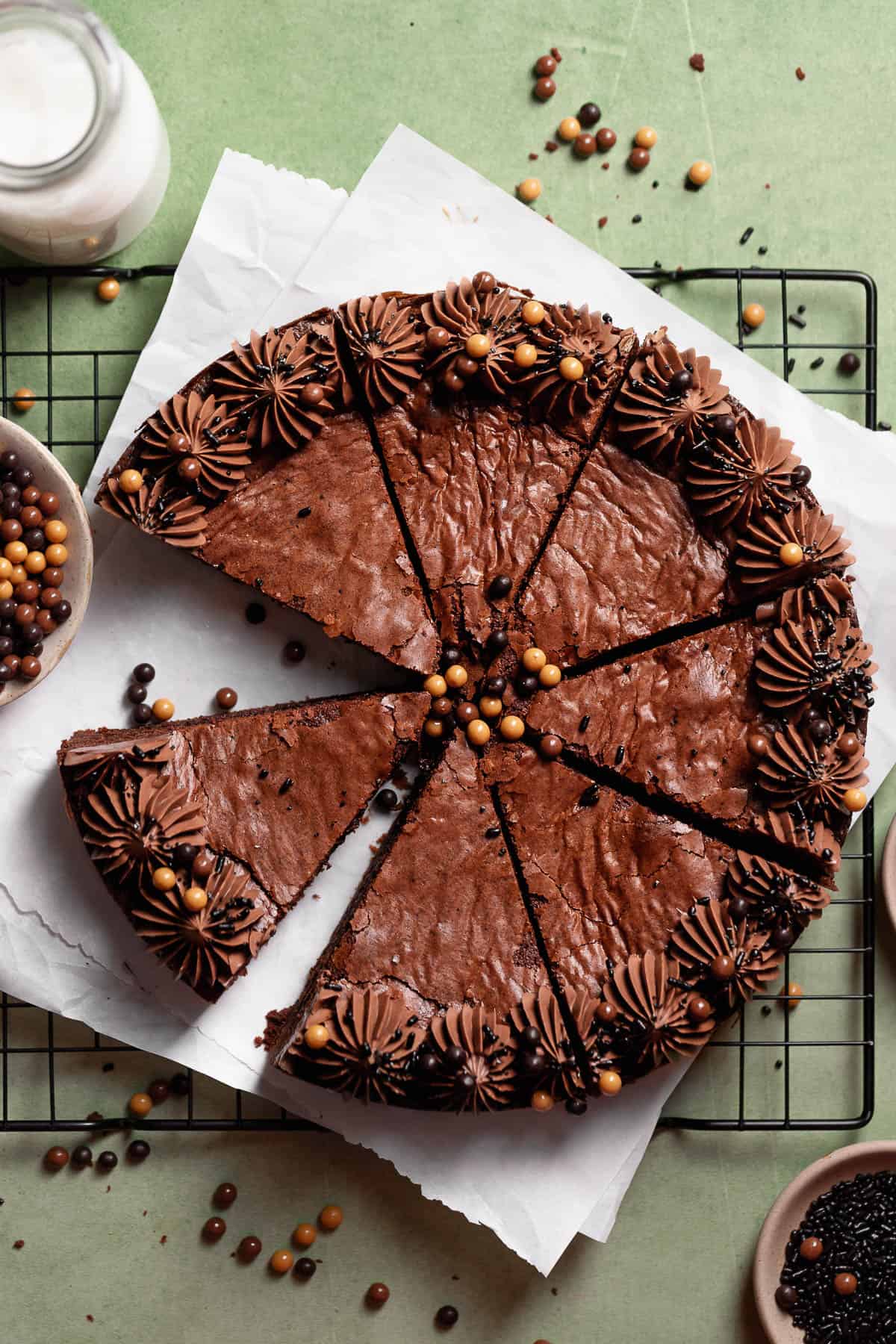 Chocolate brownie cake with milk chocolate frosting border and chocolate sprinkles.