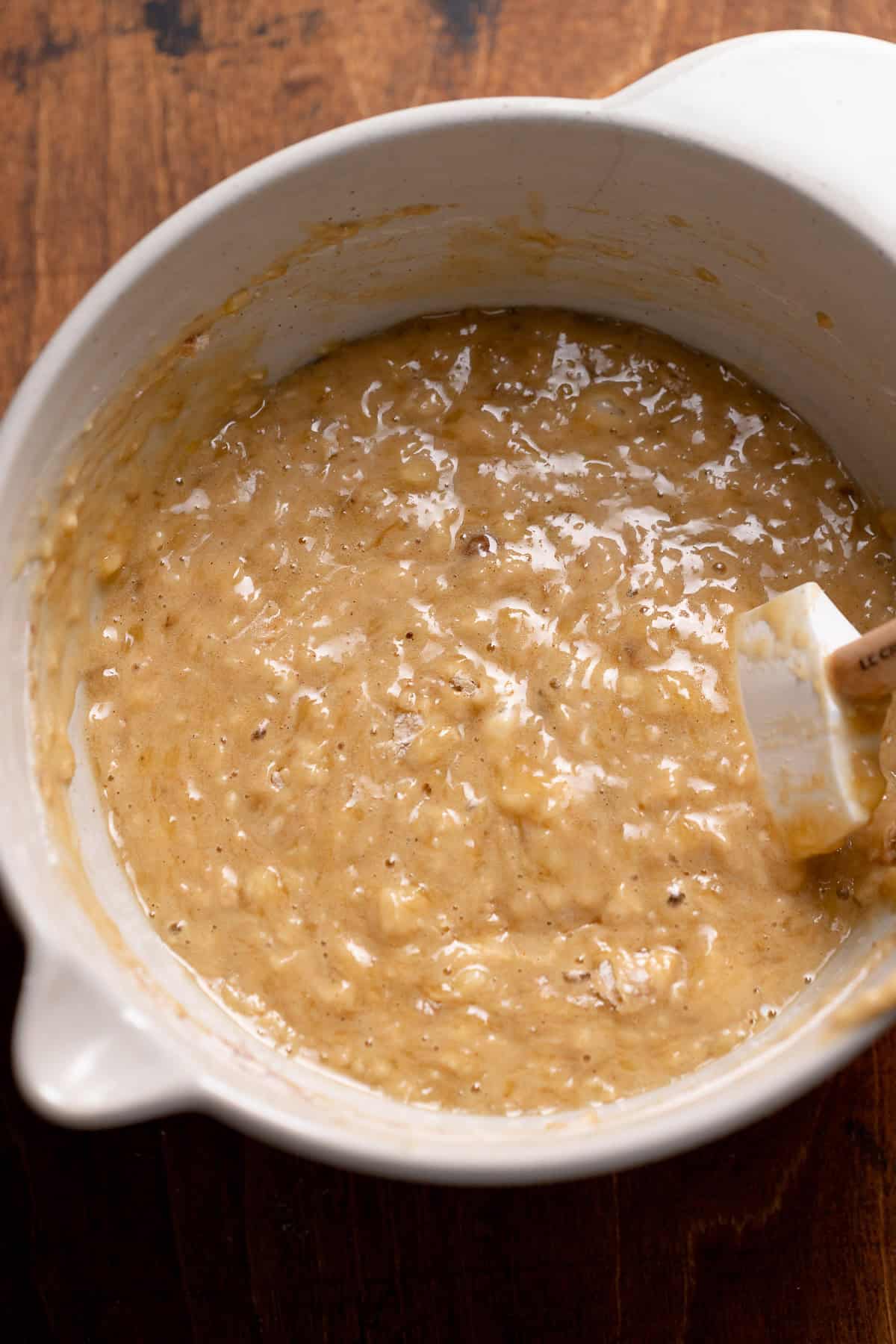 A bowl full of banana bread batter.