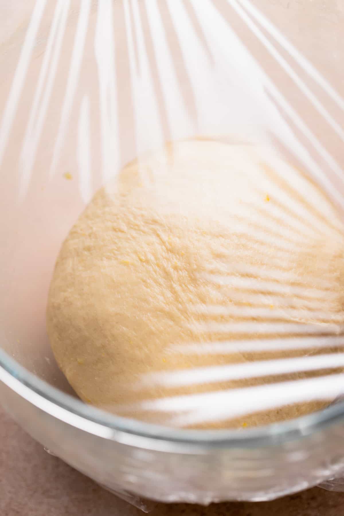 Lemon roll dough in a bowl resting before being rolled out.