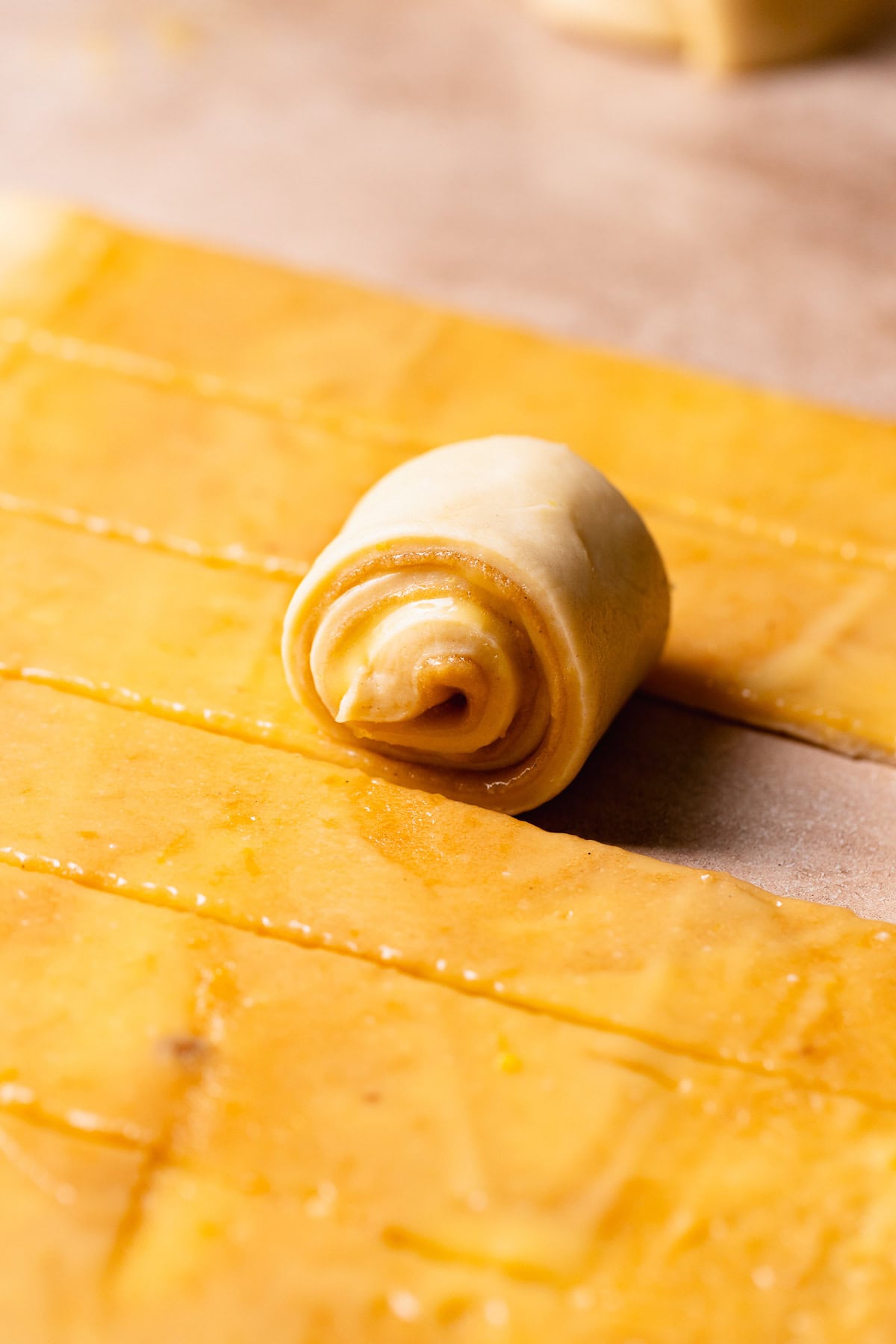 Lemon sweet rolls being rolled up.