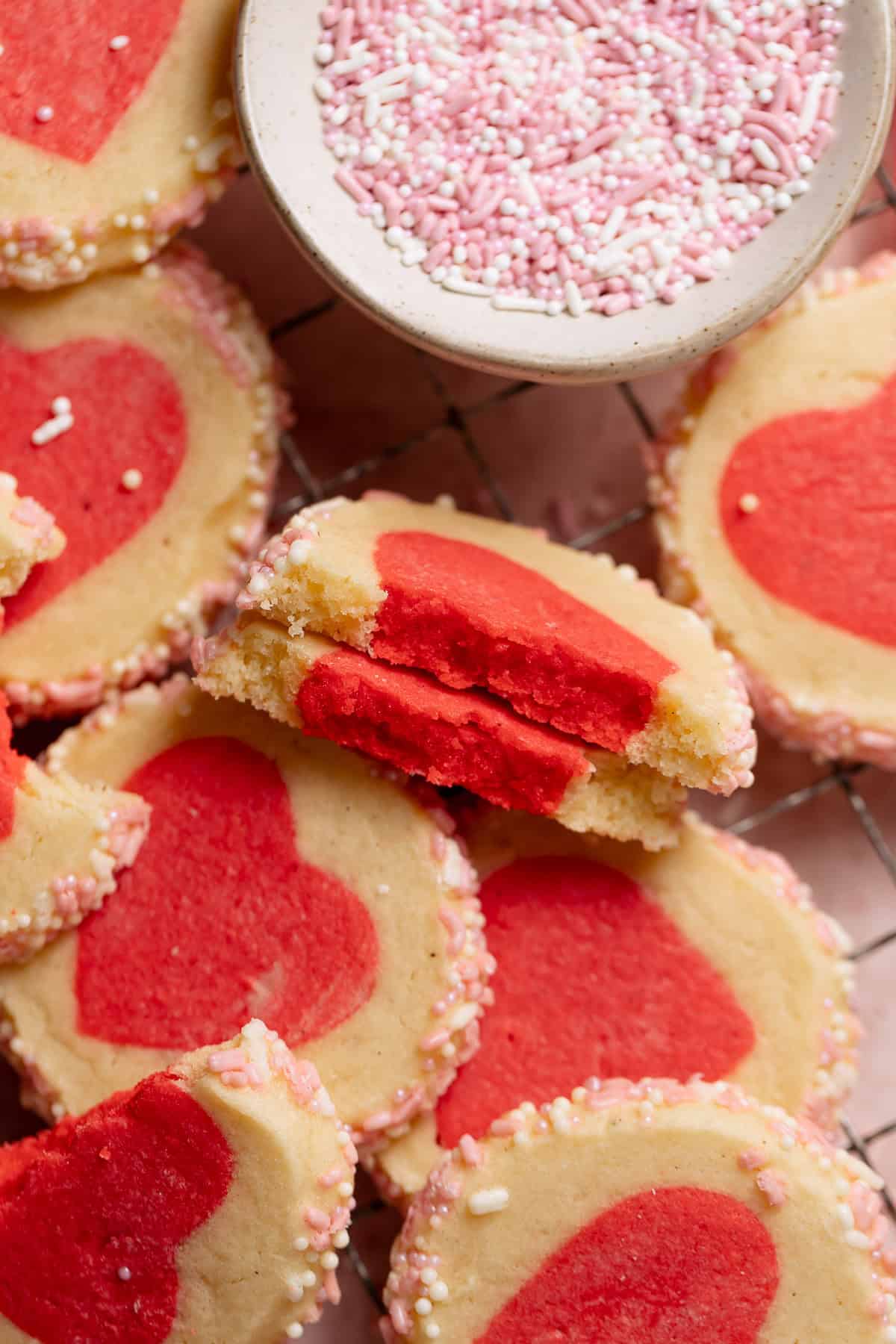 A heart cookie broken in half to show the soft and chewy texture.