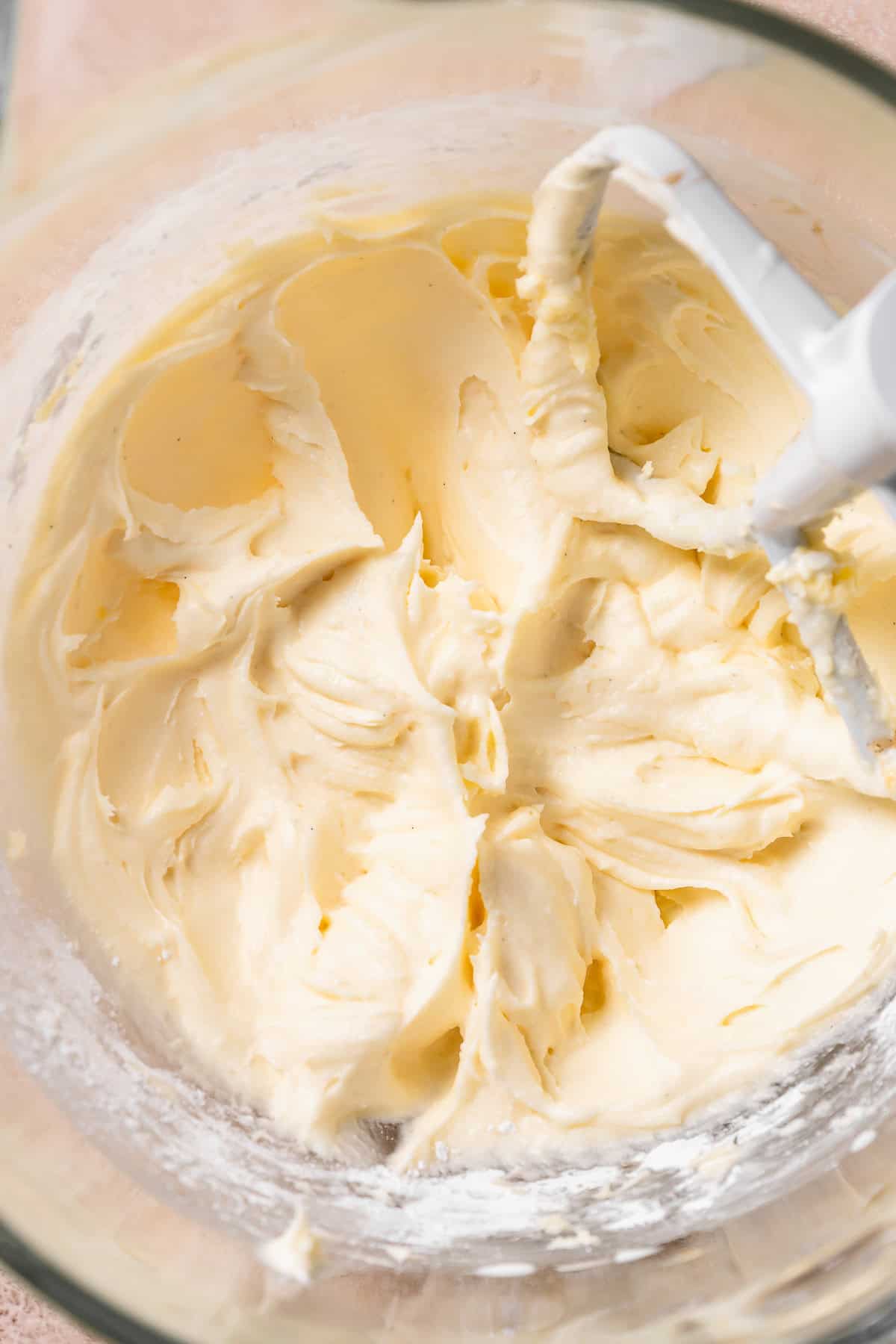 Fluffy cream cheese frosting in a mixing bowl.