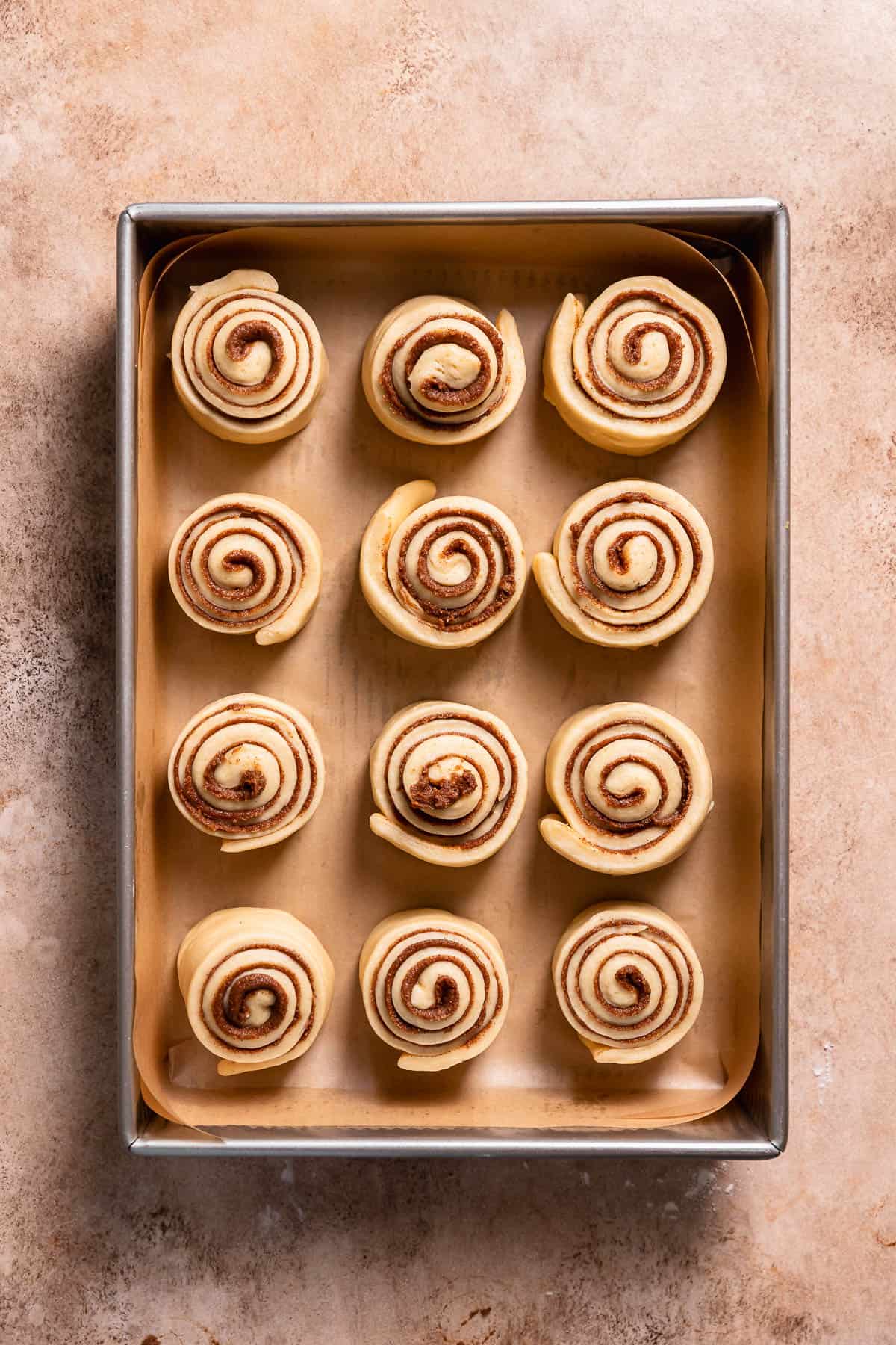 Cinnamon rolls in a baking pan before rising.