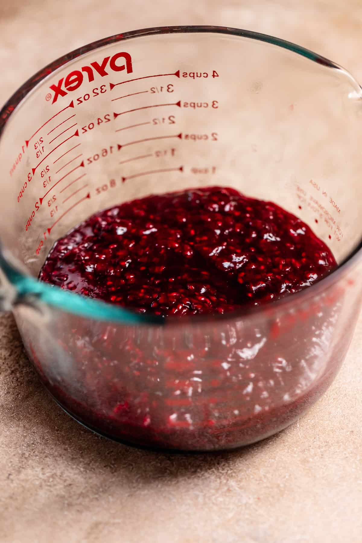 Blackberry and raspberry jam in a glass bowl.