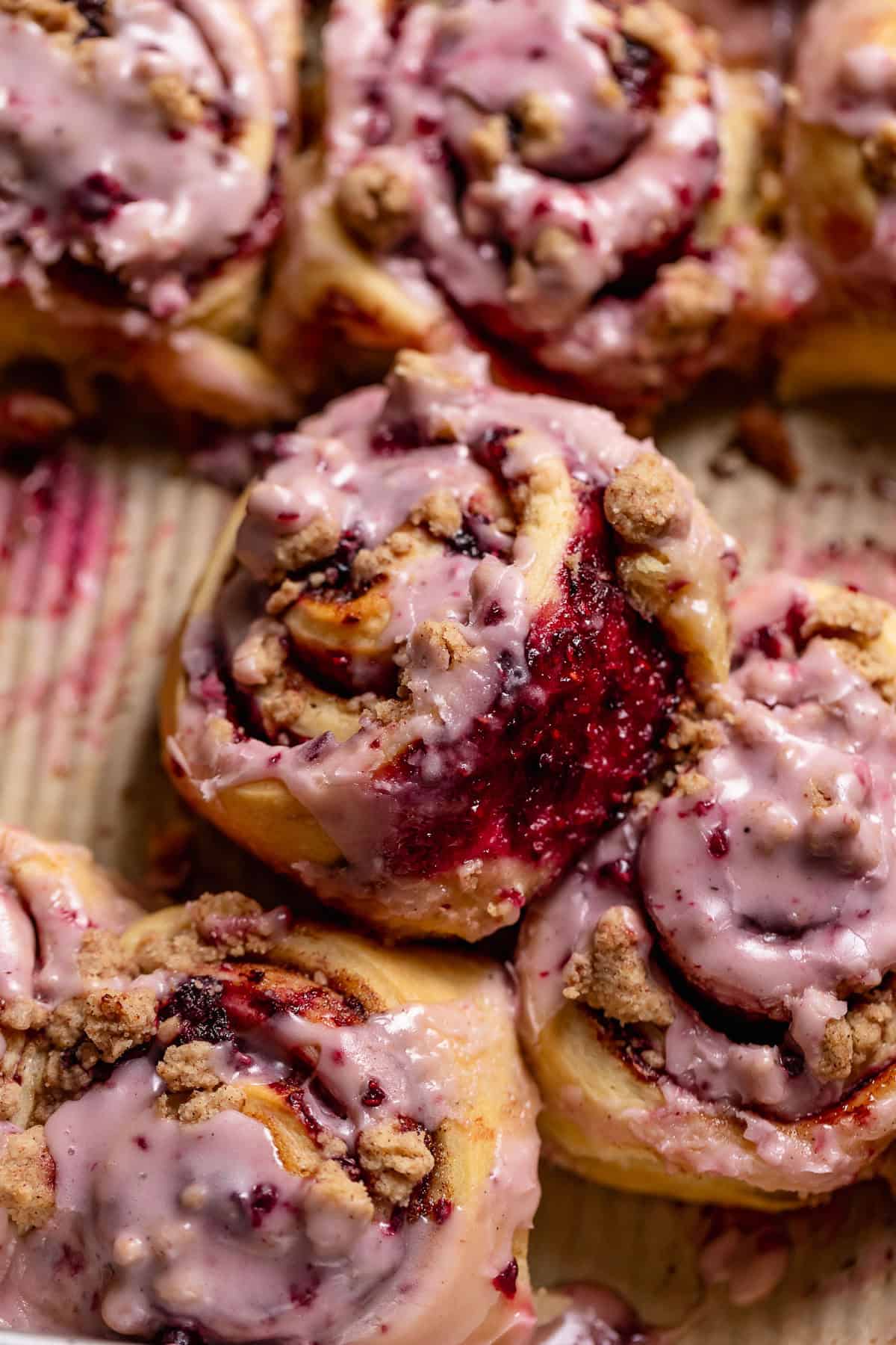 A berry roll on its side to show the jam filling.