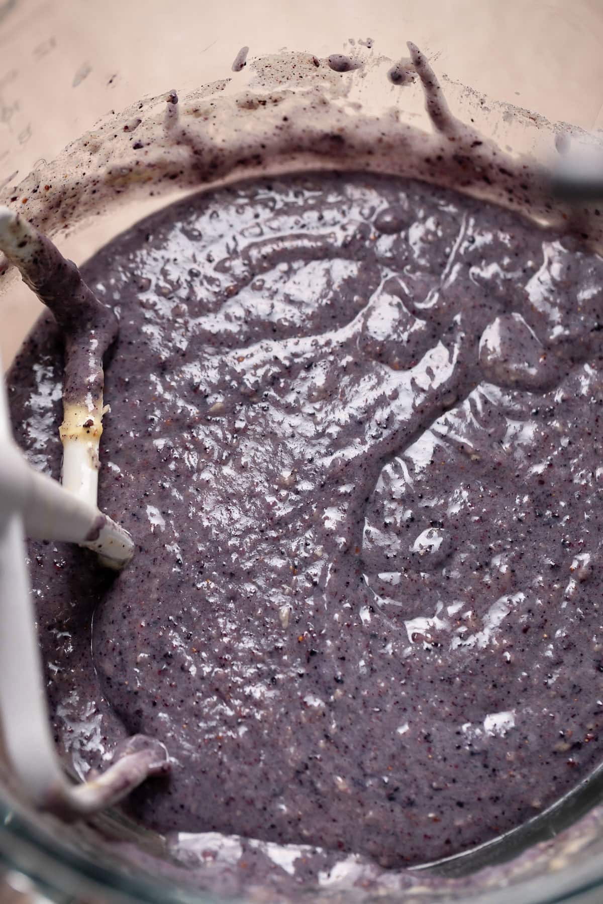 Purple blueberry cupcake batter in a mixing bowl.