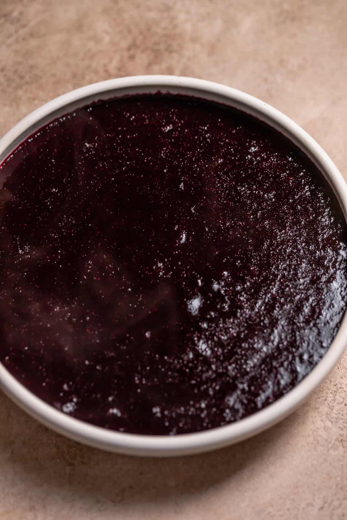 Blueberry jam filling in a white dish.