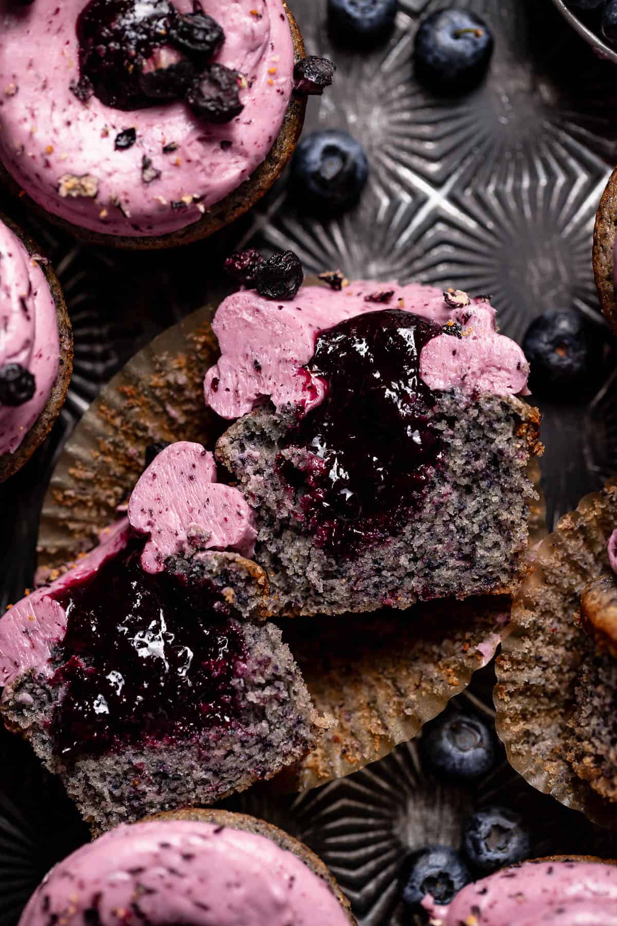 Blueberry filled cupcake cut in half to show the blueberry jam centers.