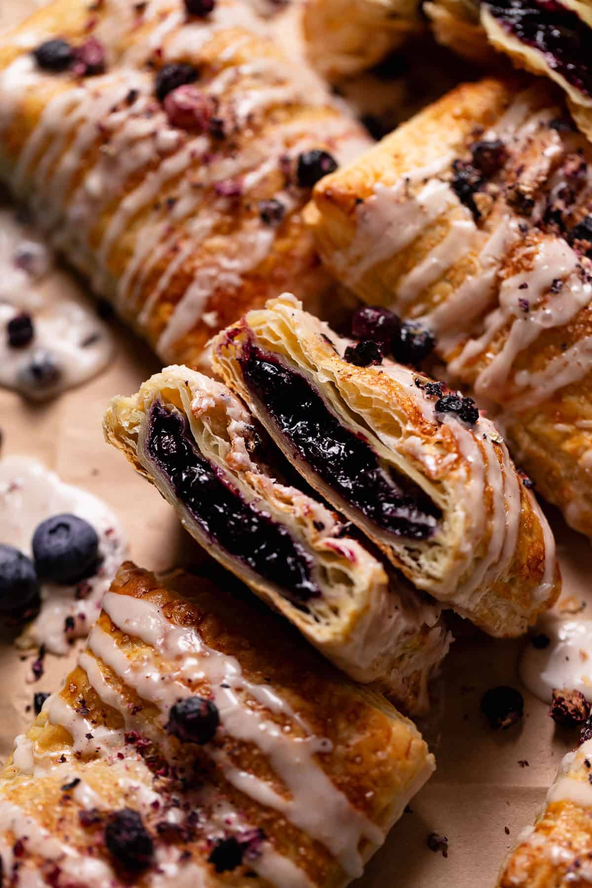 A toaster pastry broken in half to show the gooey blueberry jam filling.