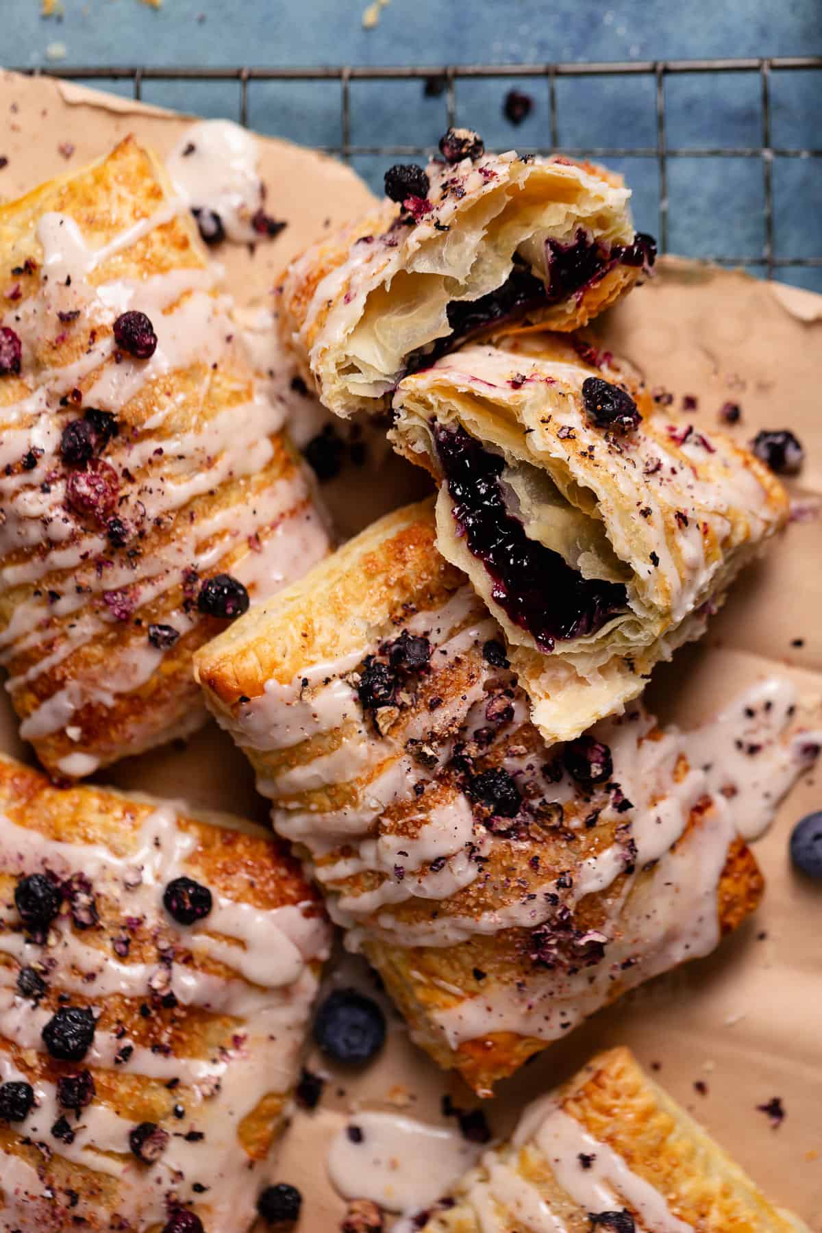 Homemade toaster strudels with blueberry filling drizzled with vanilla icing.