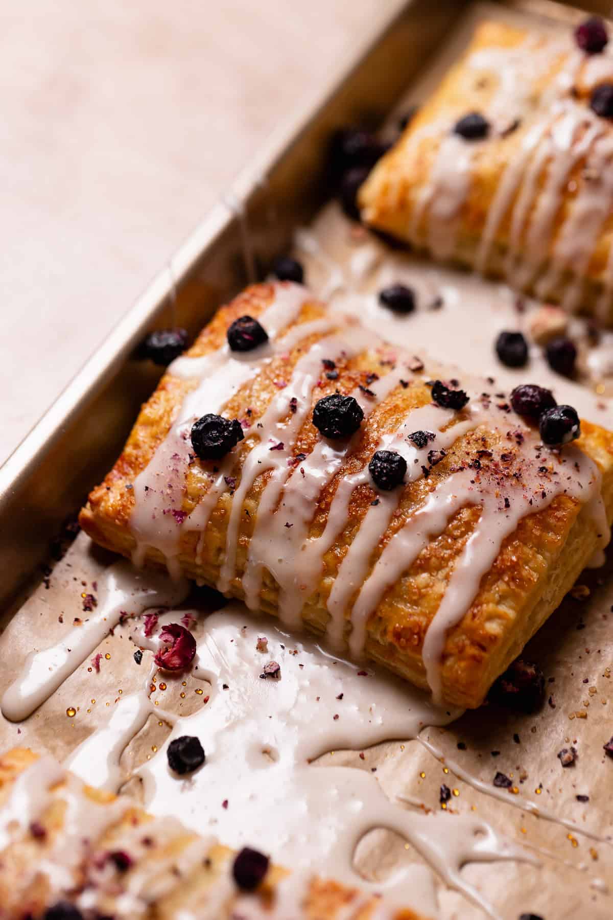 Baked toaster strudel drizzled in vanilla icing and sprinkled with dried blueberries.