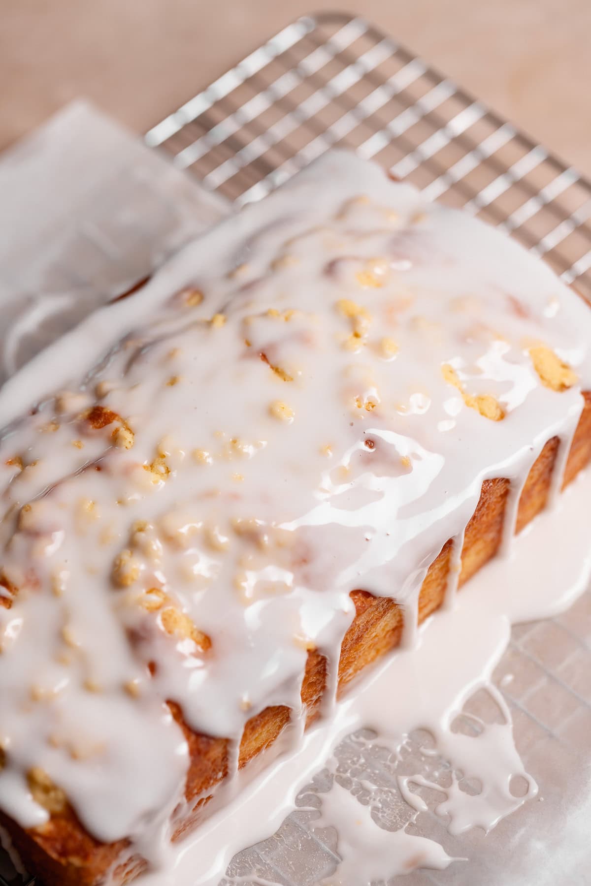 The iced lemon loaf on parchment paper before cutting.